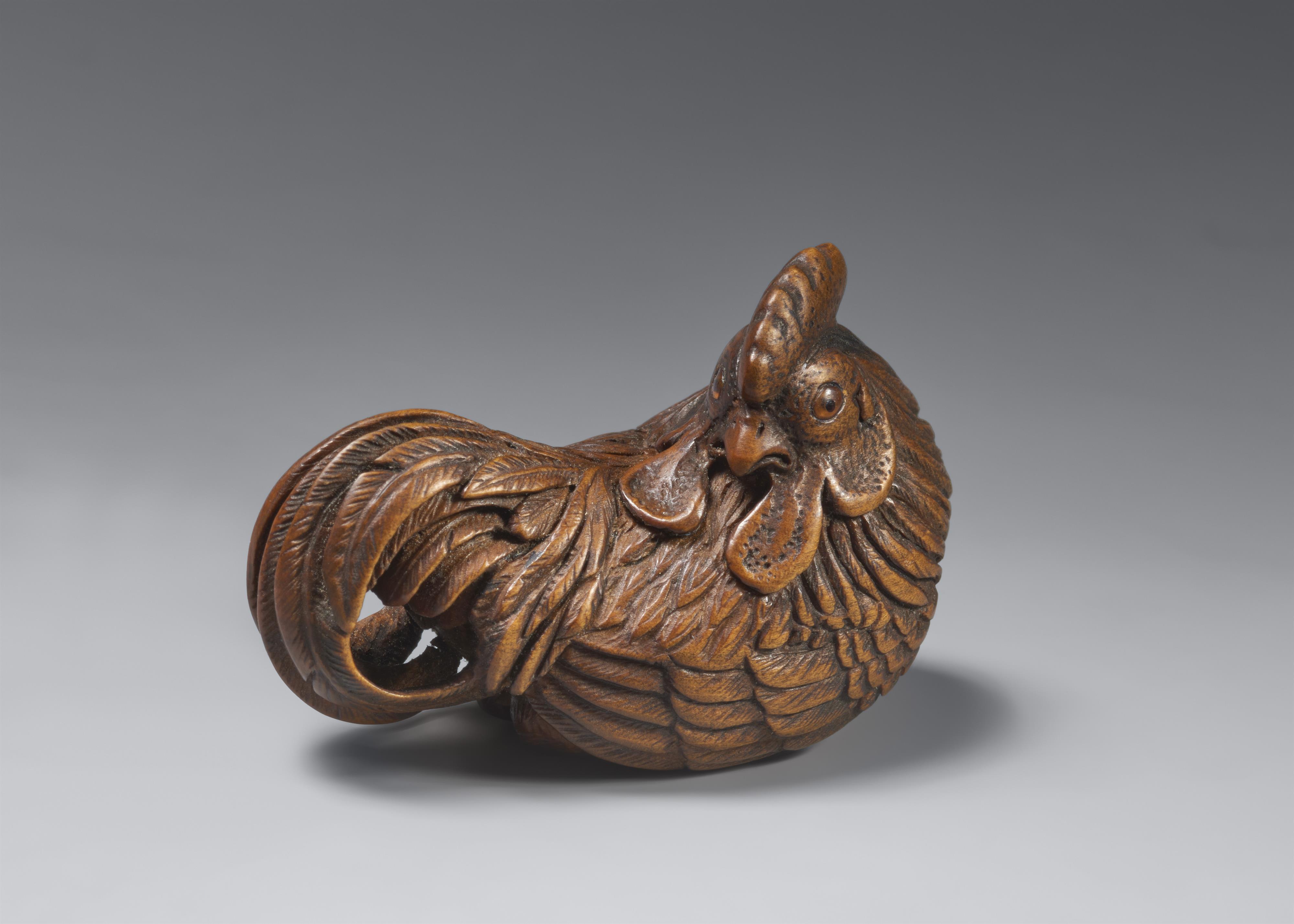 A wood netsuke of a proud rooster. - image-1