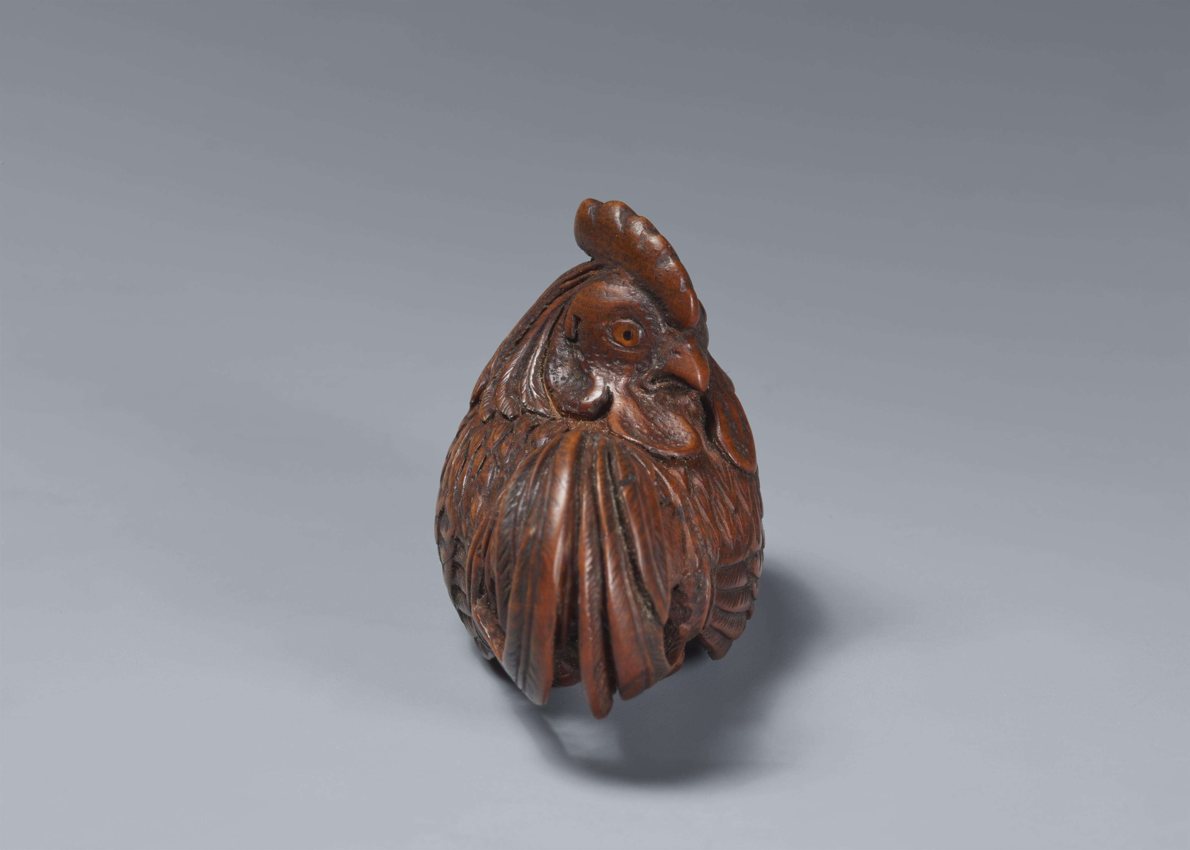 A wood netsuke of a proud rooster. - image-3