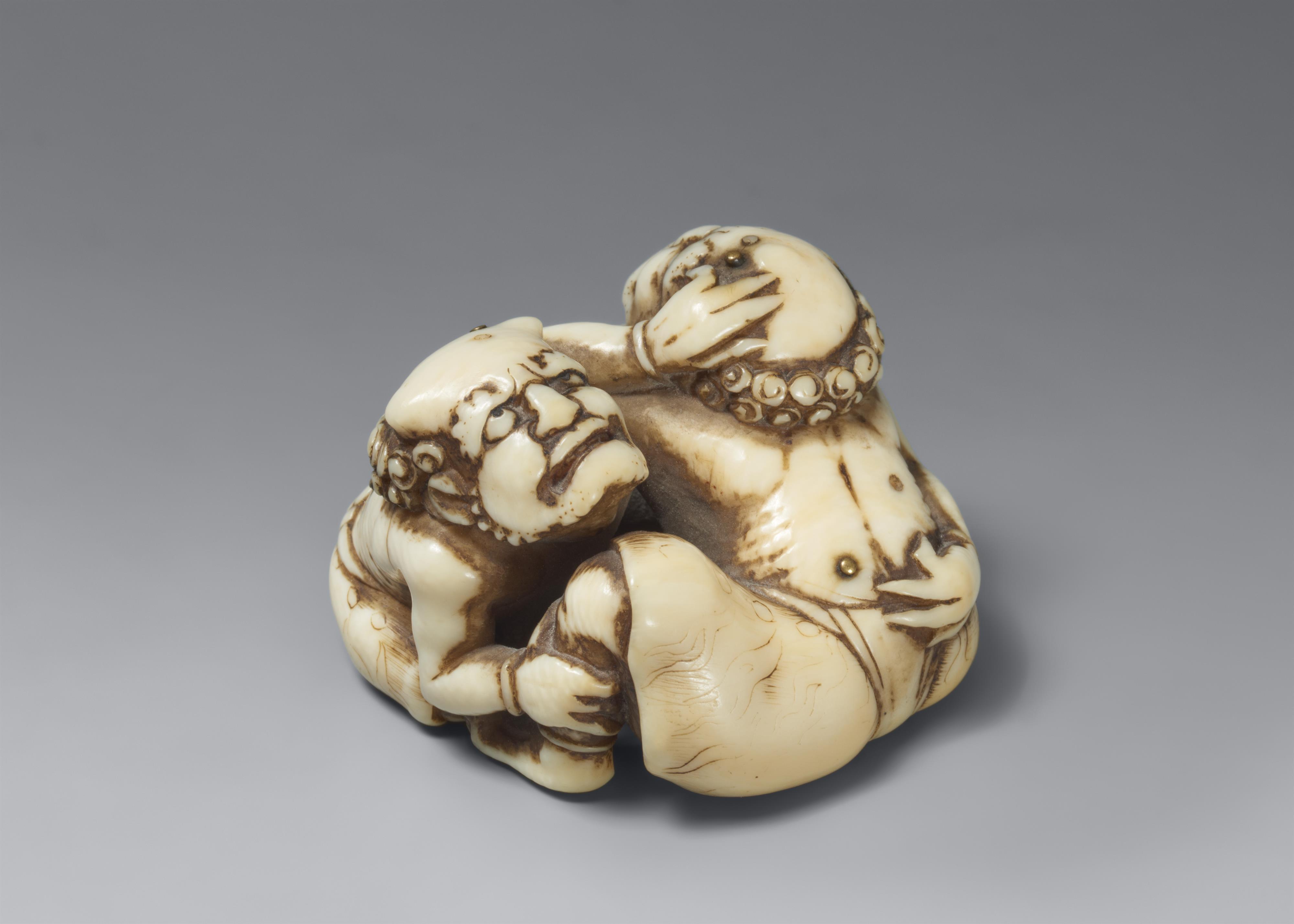 An ivory netsuke of two grumpy oni. Mid-19th century - image-1