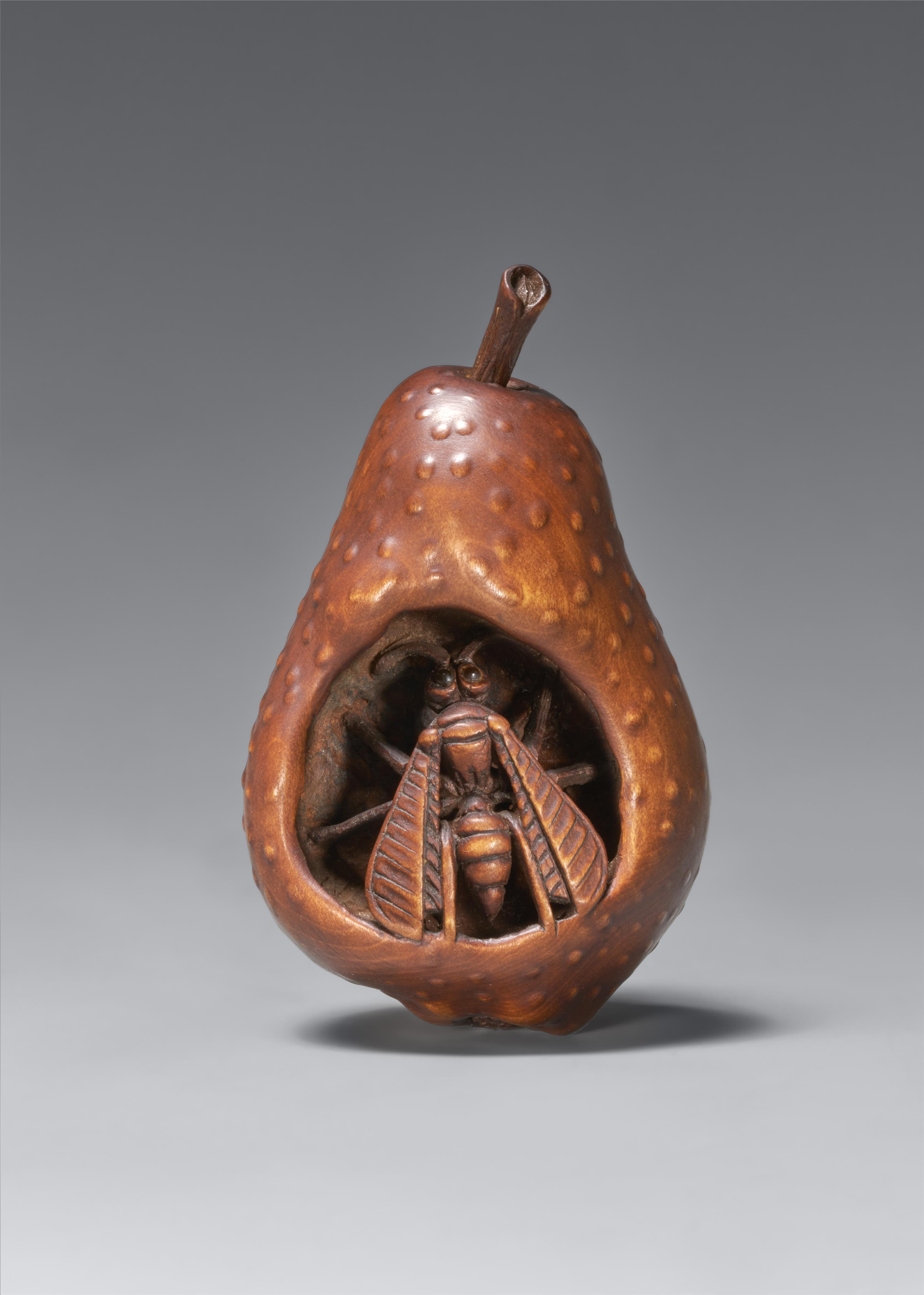 A wood netsuke of a wasp in rotting pear. In the style of Sangetsu. Nagoya. Second half 19th century - image-1