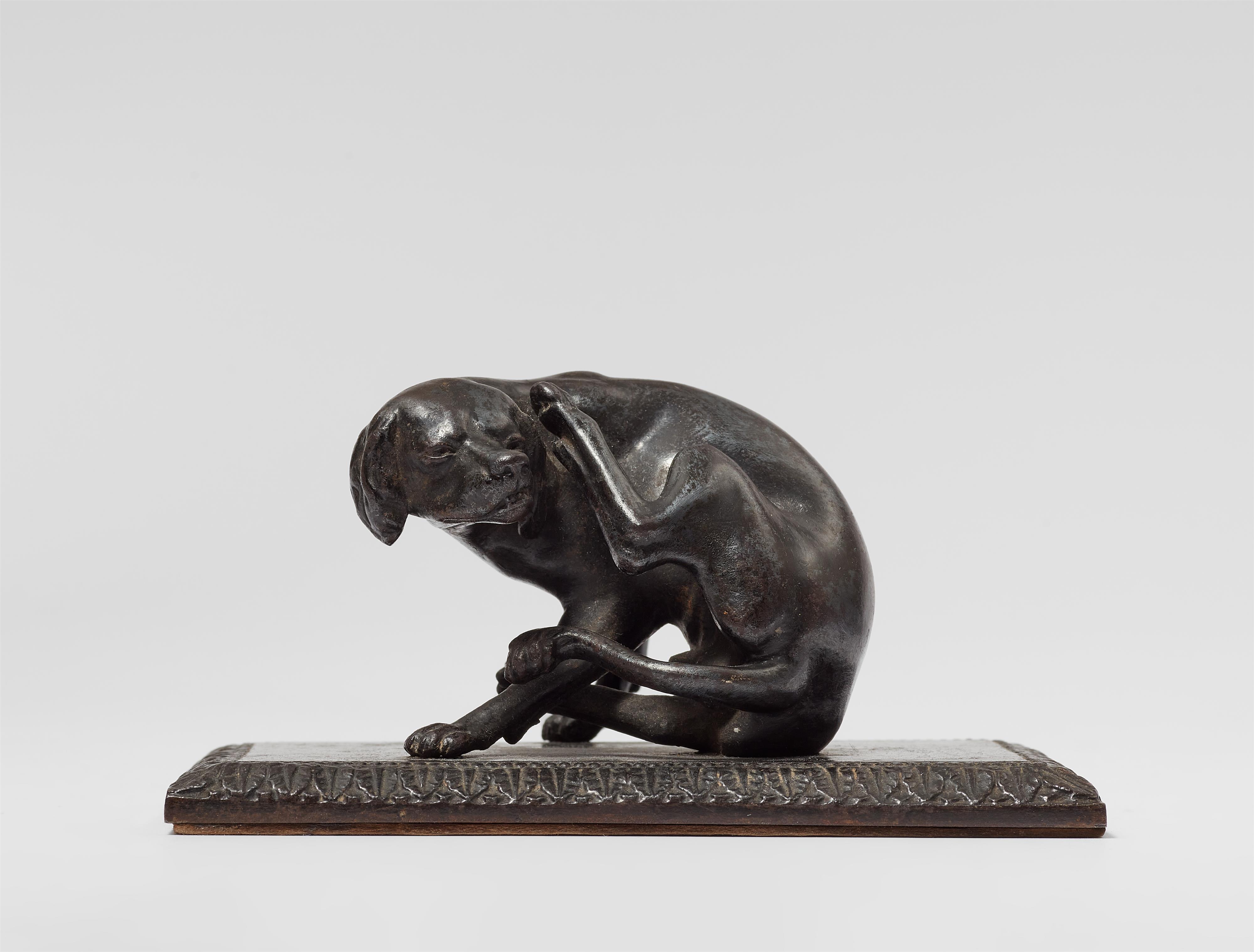 A cast iron paperweight with a hunting dog - image-1
