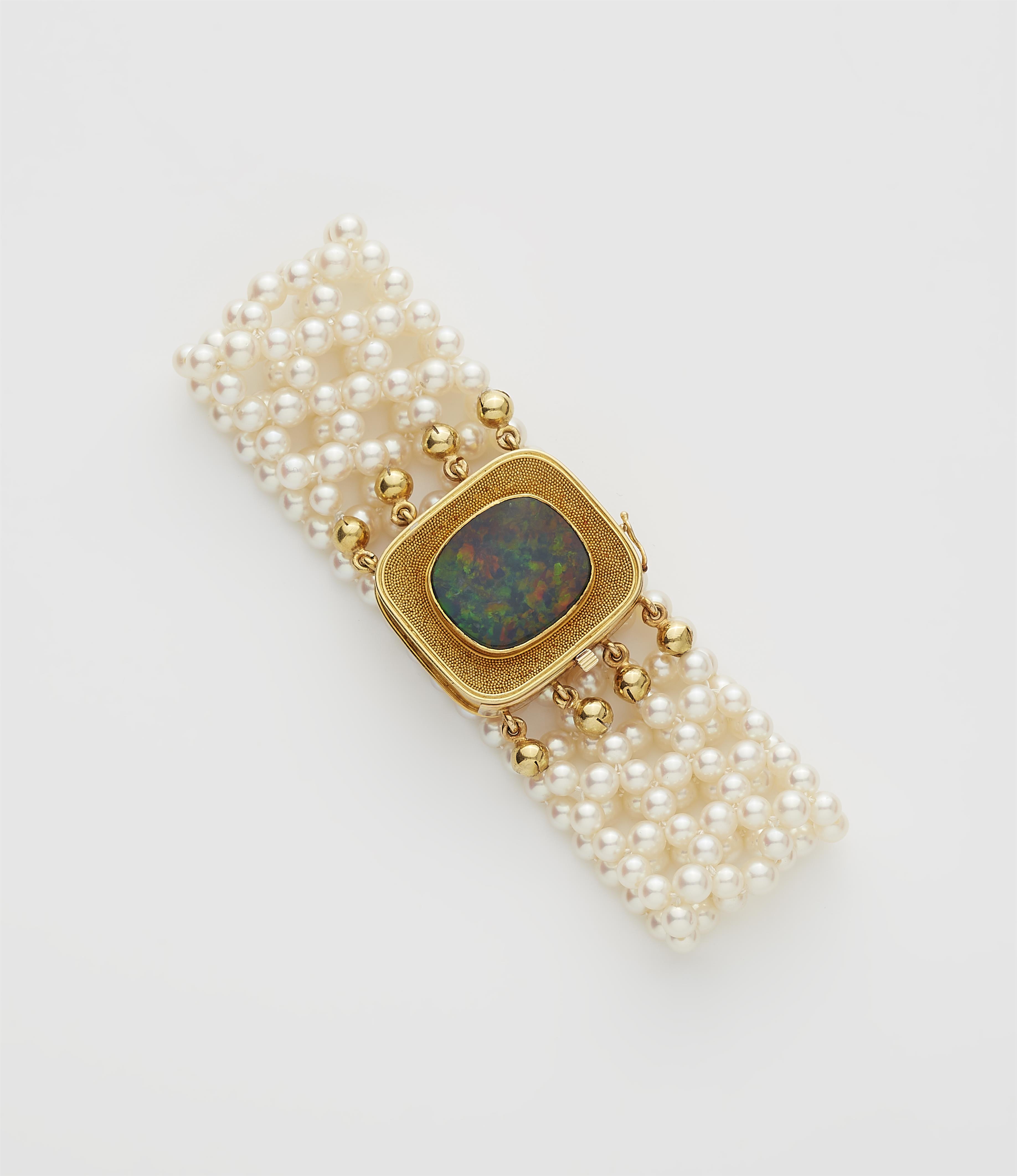 A woven cultured pearl bracelet with an 18k gold and black opal clasp. - image-1