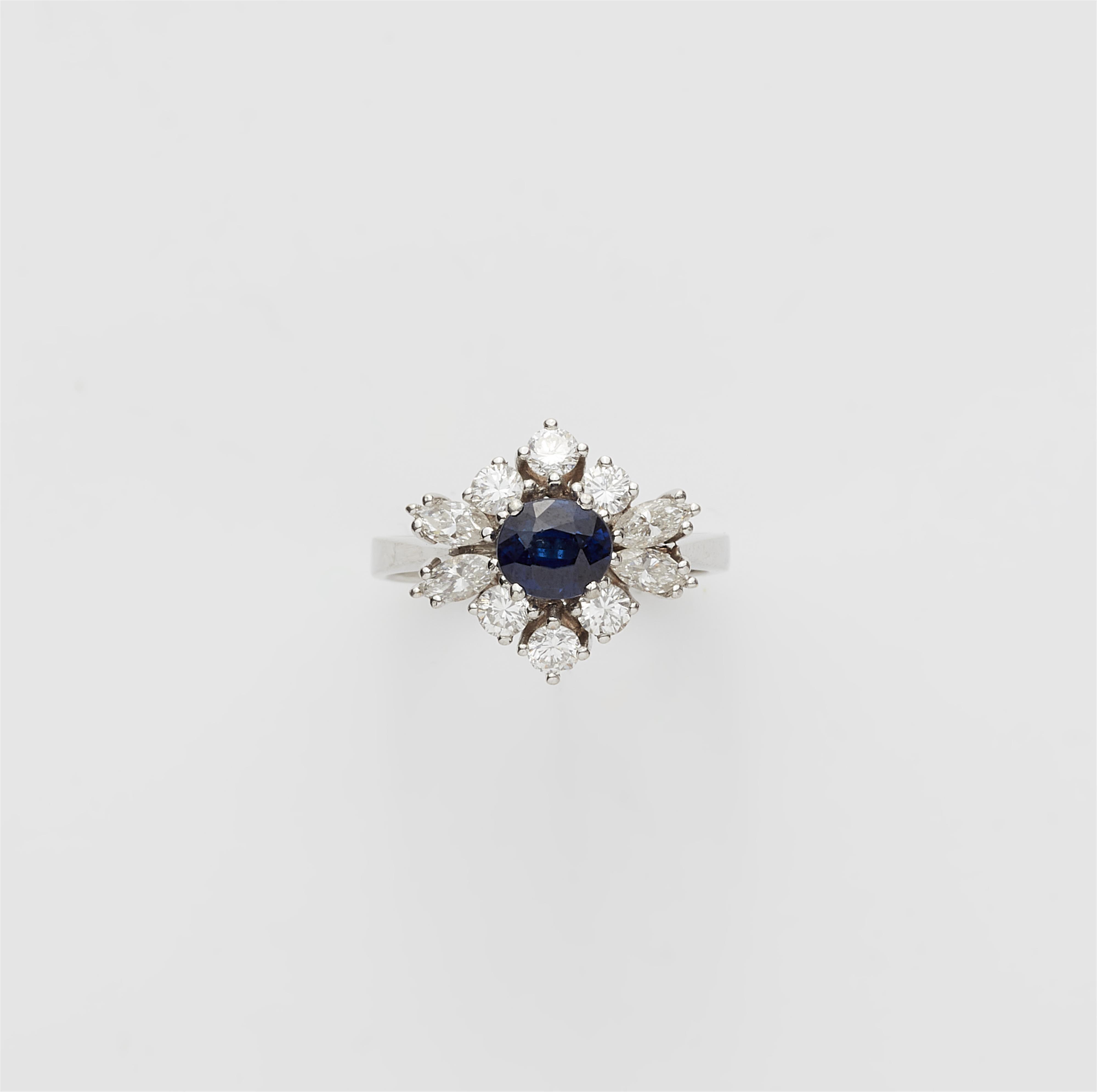 An 18k white gold diamond and sapphire cluster ring. - image-1