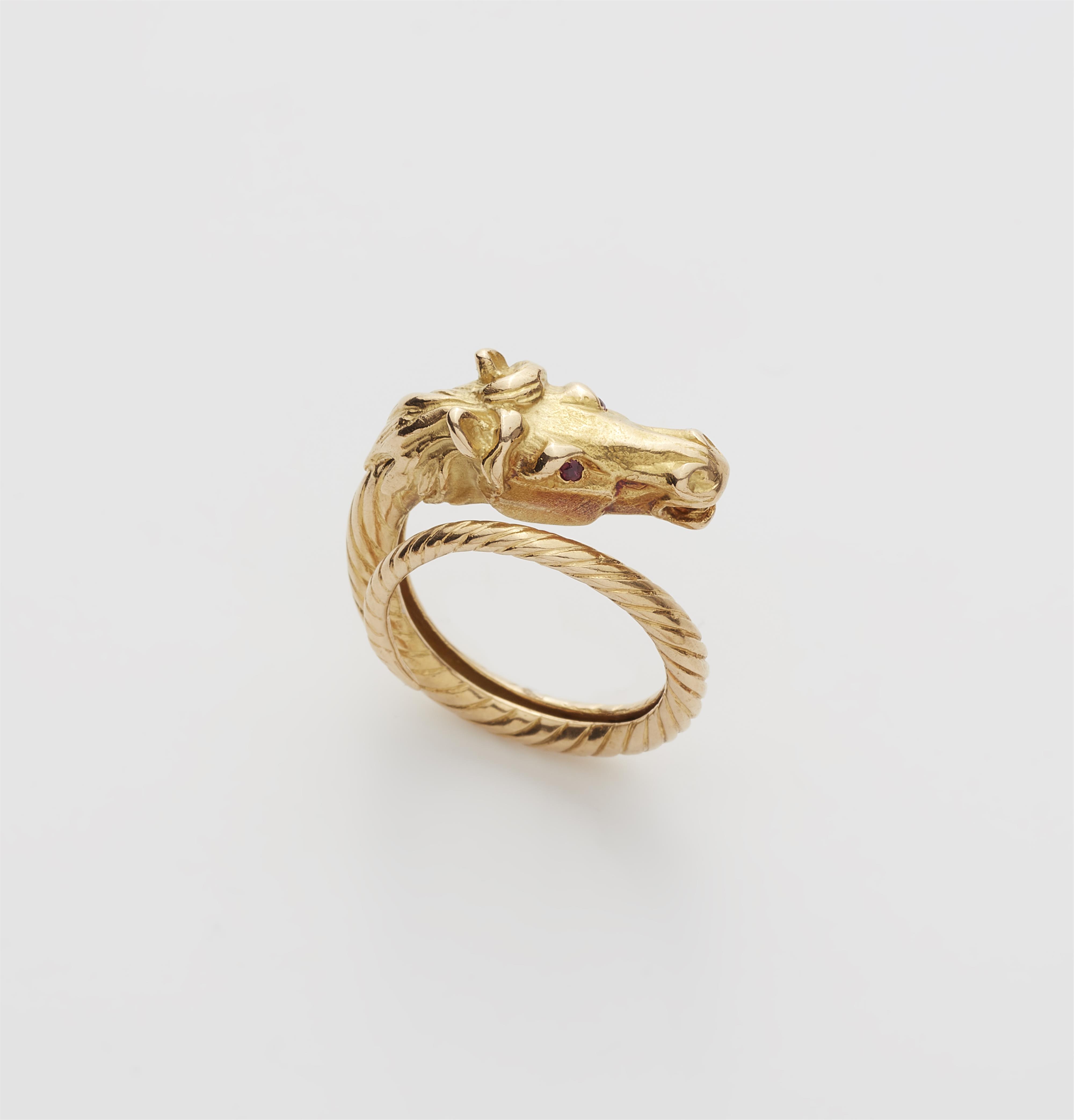 An 18k gold and ruby horse ring. - image-1