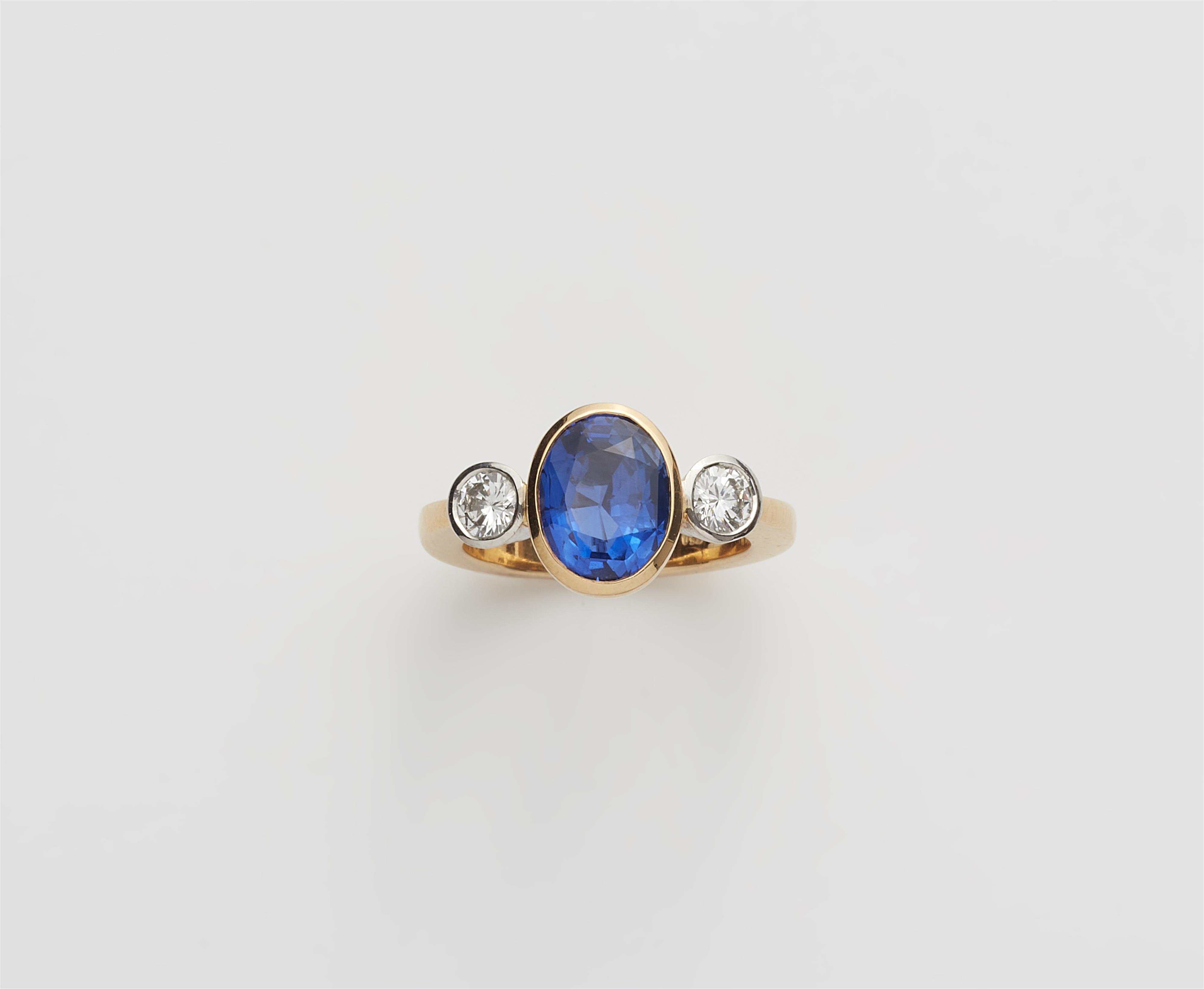 A German 18k gold diamond and natural sapphire three stone ring. - image-2