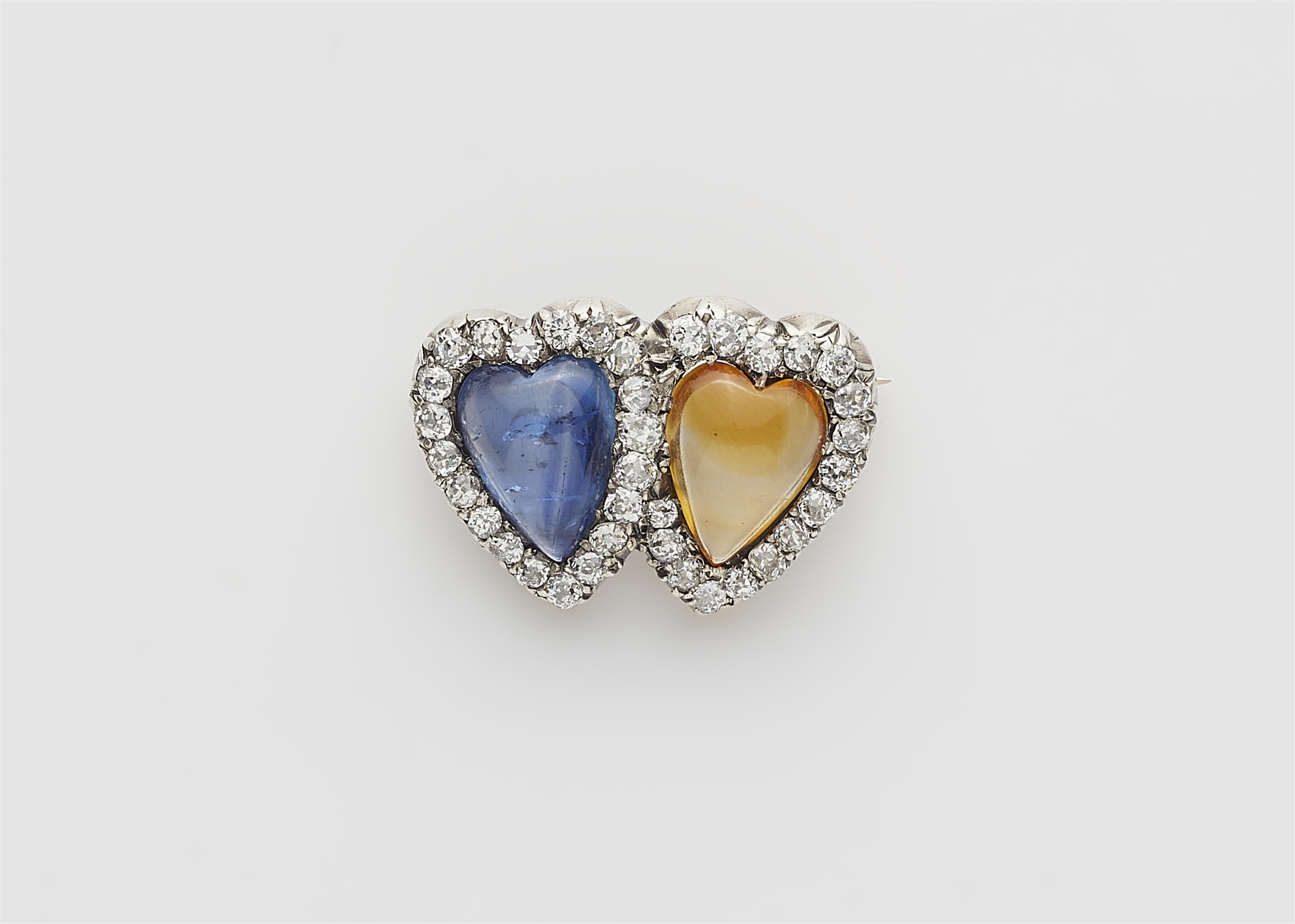 A Victorian 14k gold and coloured sapphire brooch designed as a pair of connected hearts. - image-1