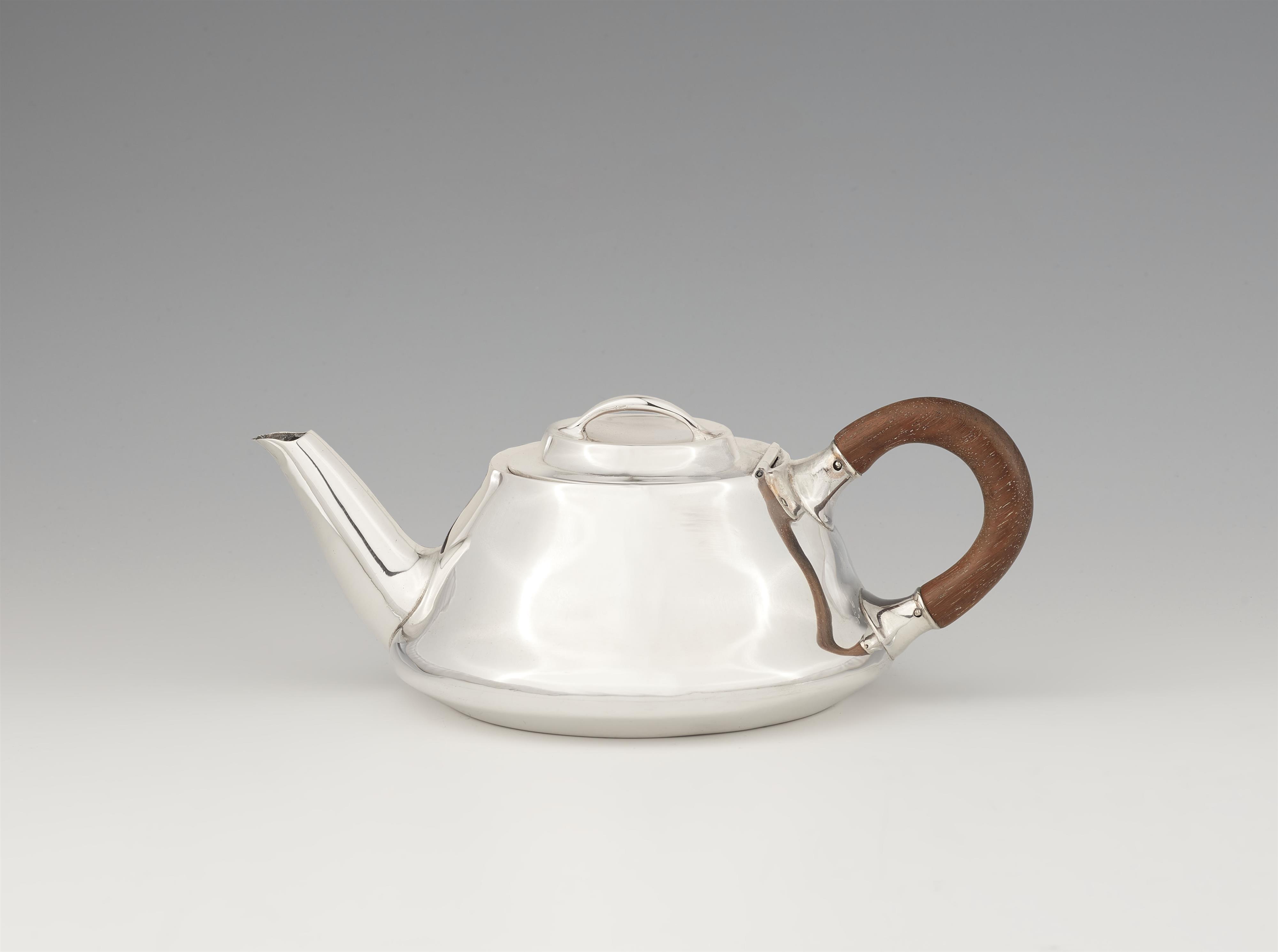An Arts and Crafts silver teapot - image-1