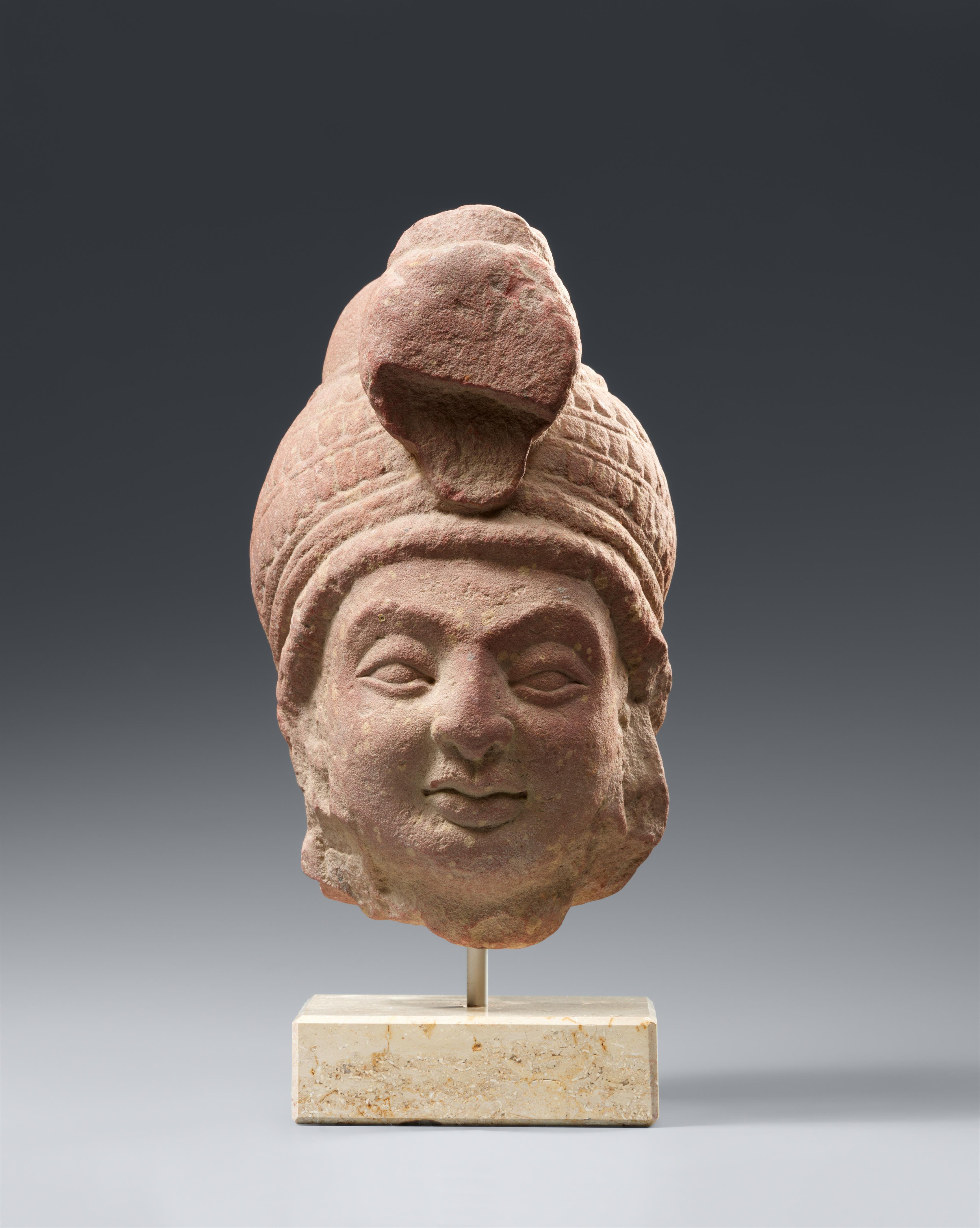 A Mathura mottled pink sandstone head of a bodhisattva. Northern India, Kushana empire. Around 2nd century - image-1