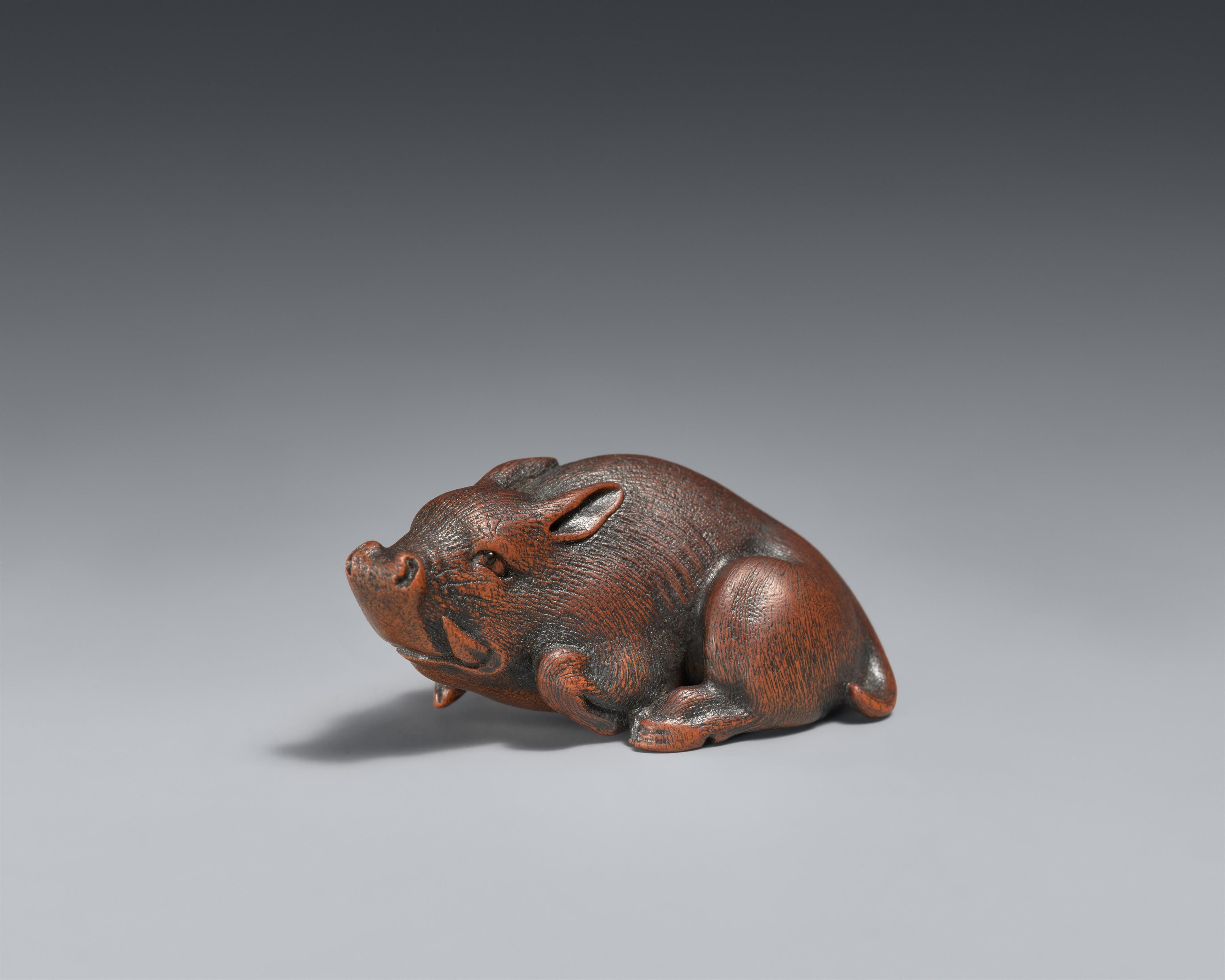 A small boxwood netsuke of a recumbent boar. Nagoya. Mid-19th century - image-1