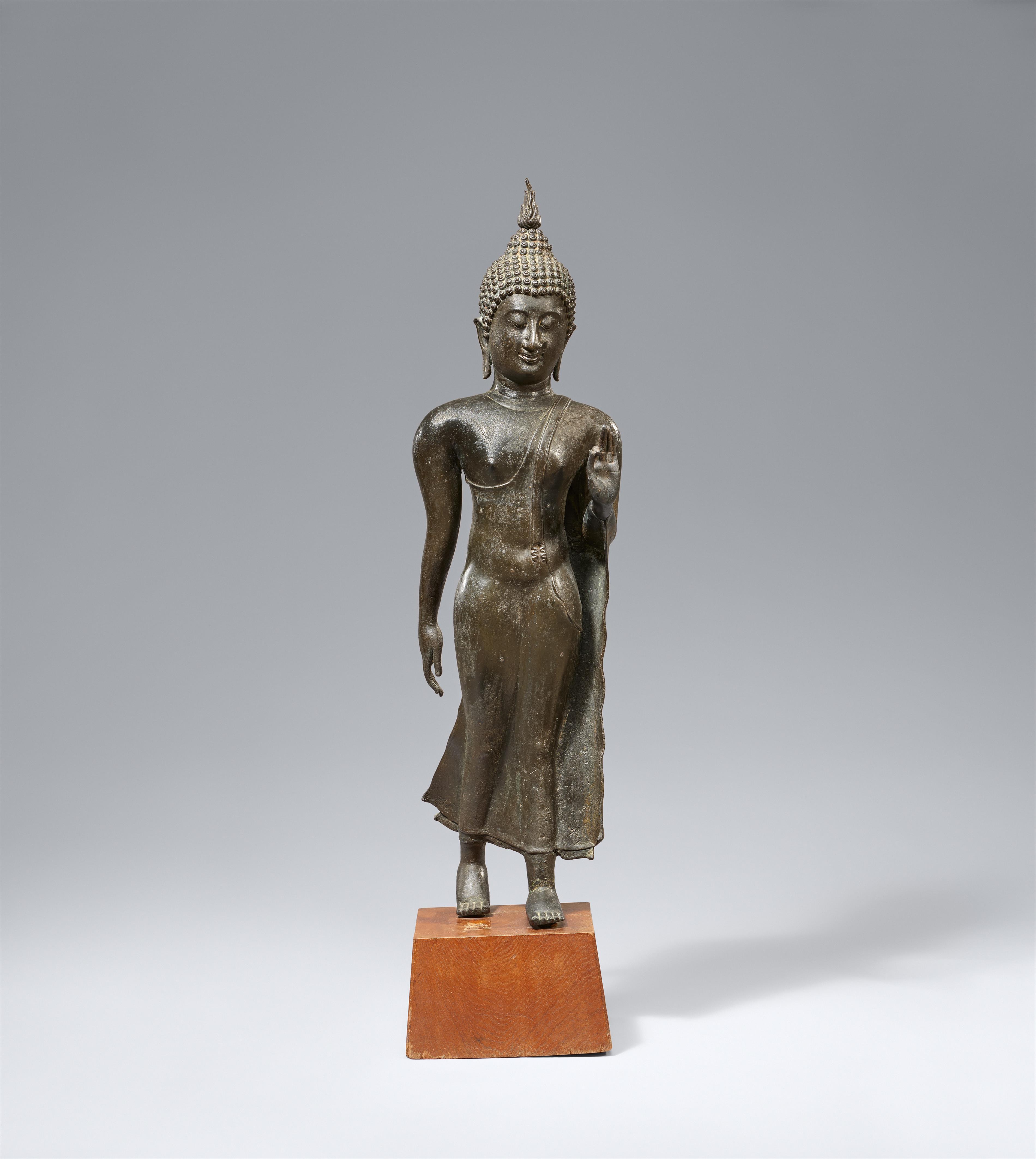 A Sukhothai-style bronze figure of a walking Buddha. Thailand. 14th century or later - image-1