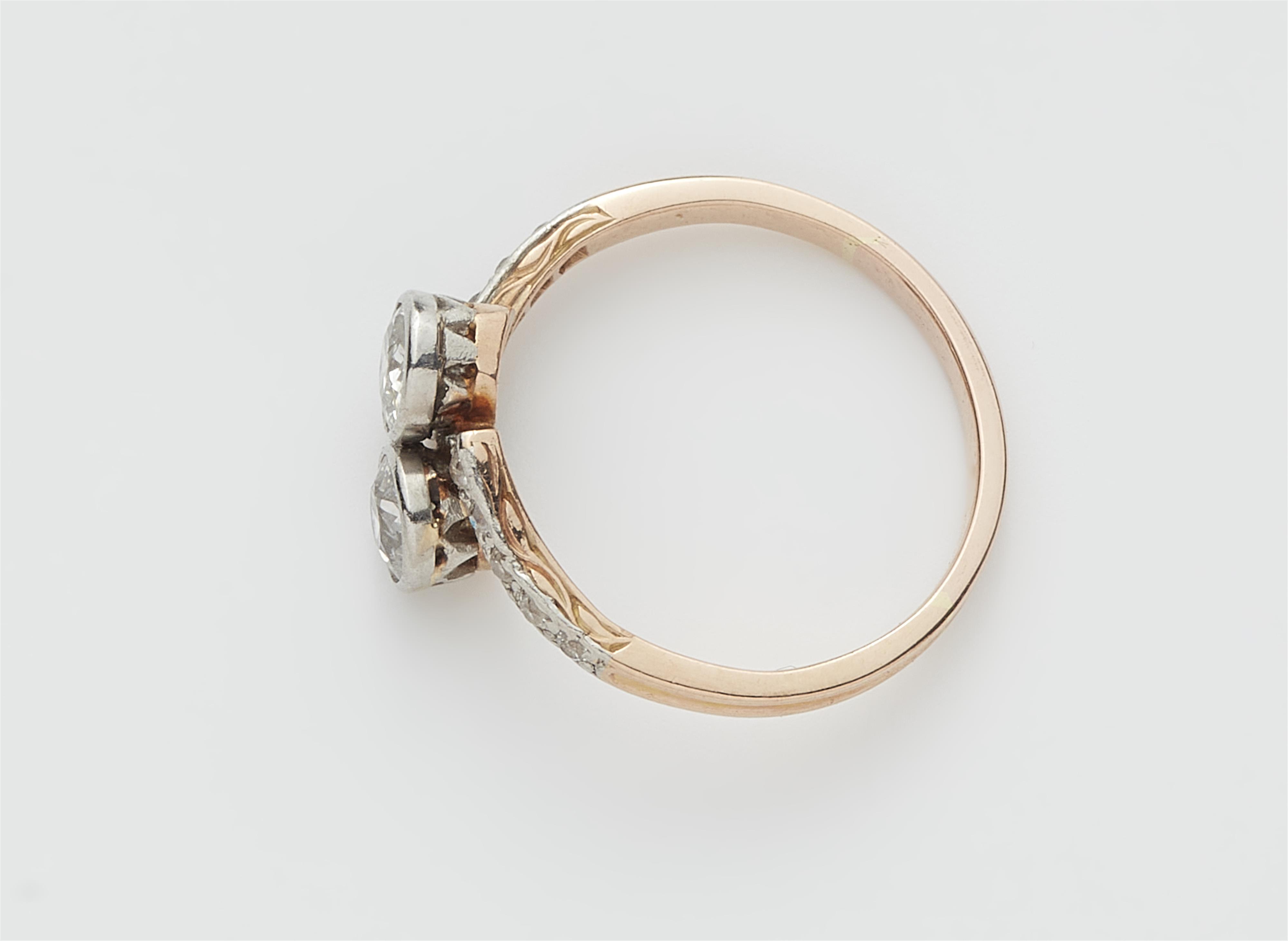 An early 20th century 14k red gold and diamond crossover ring. - image-2