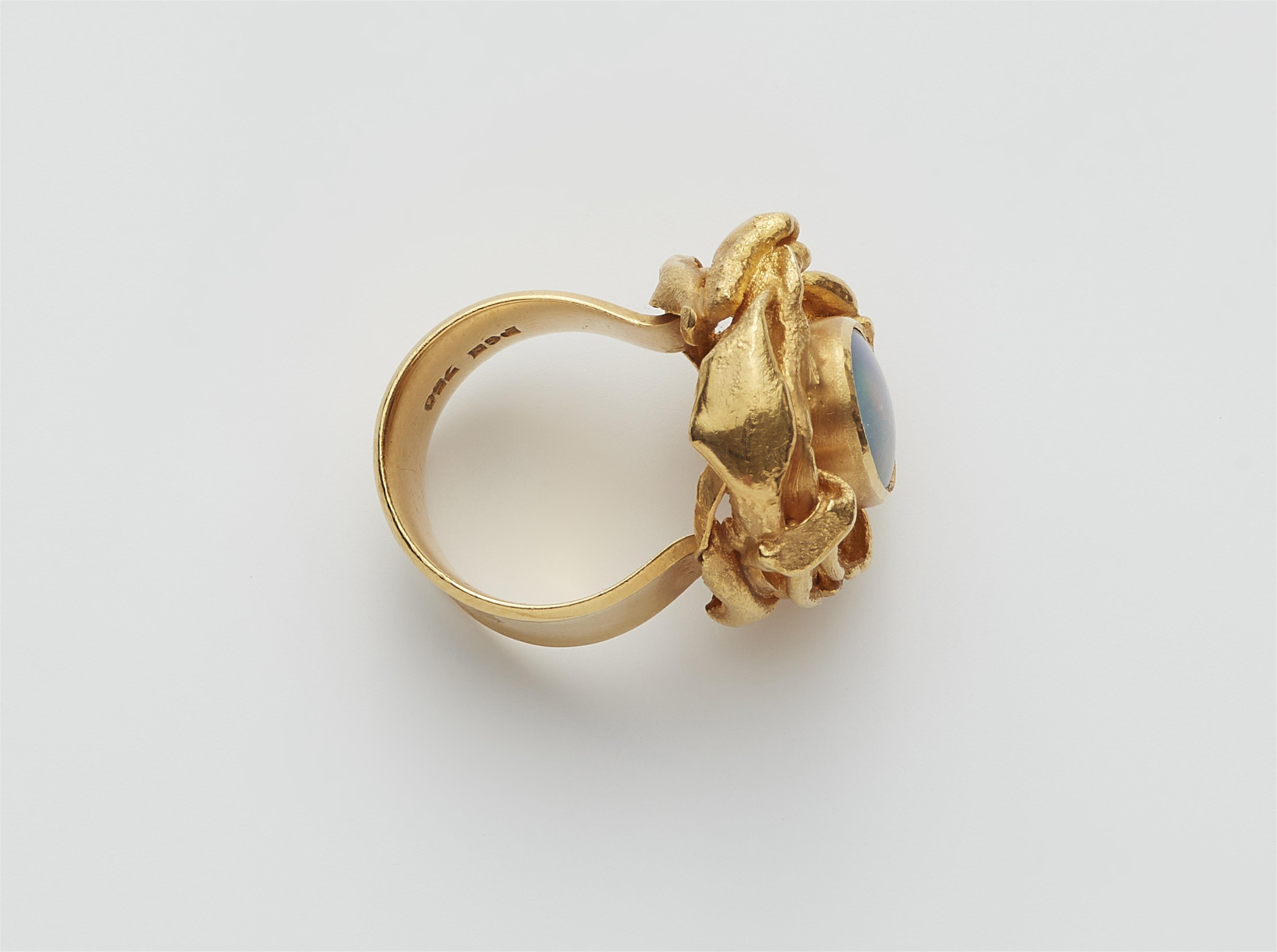A German 18k gold and harlekin opal triplet ring. - image-2