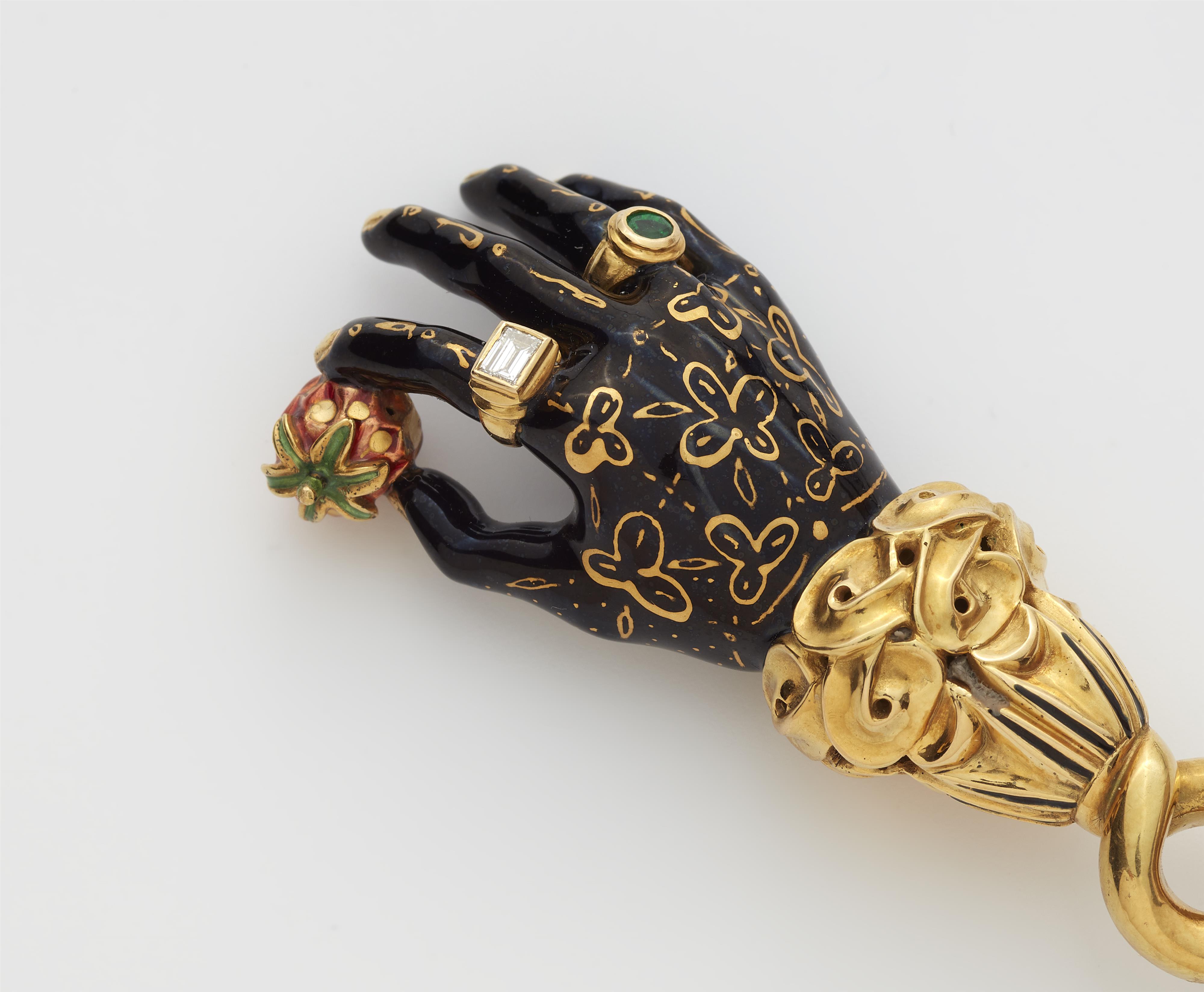 A German 18k gold enamel hand pendant holding a strawberry. - image-3