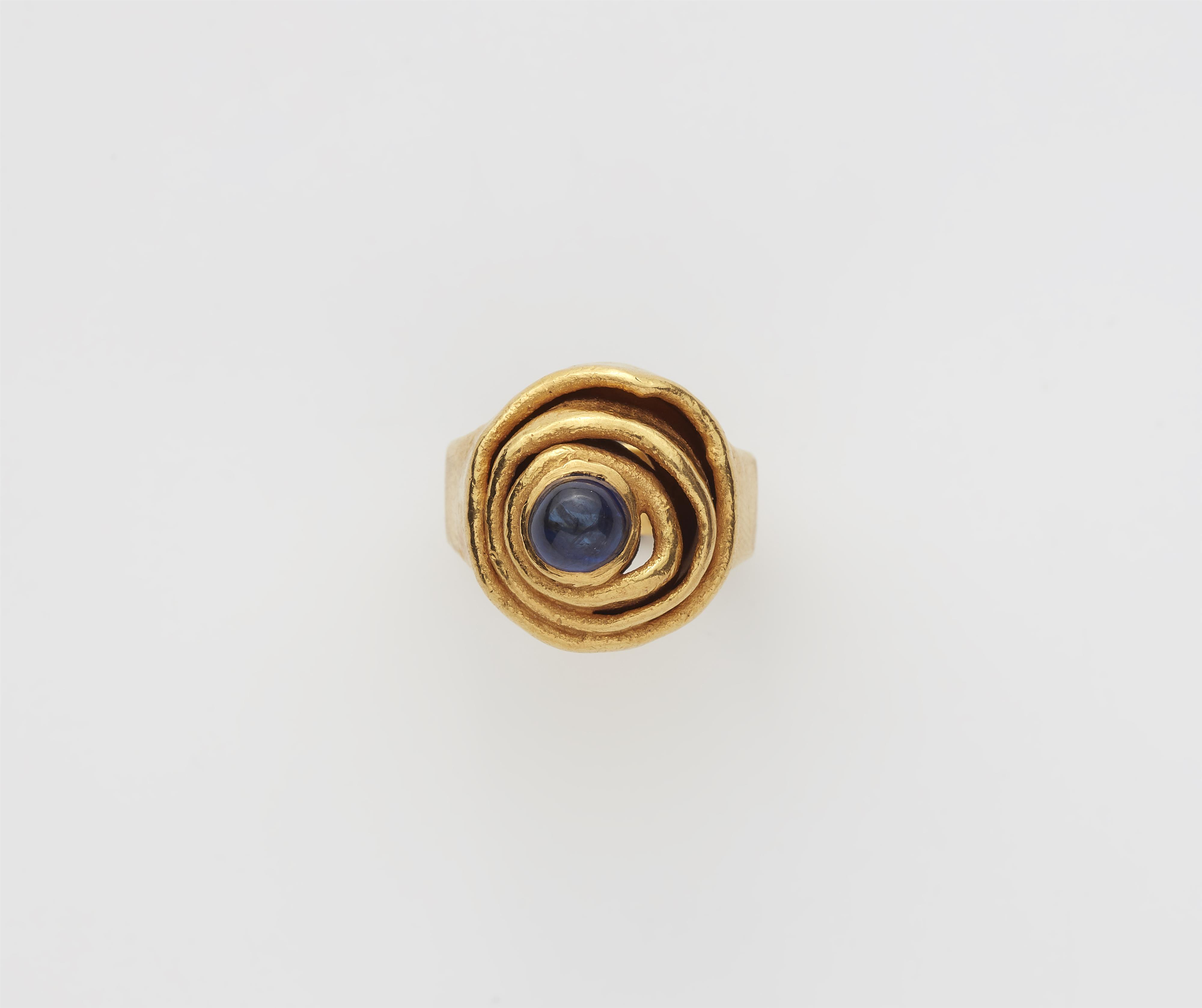 A German forged 21k gold and sapphire cabochon ring. - image-1