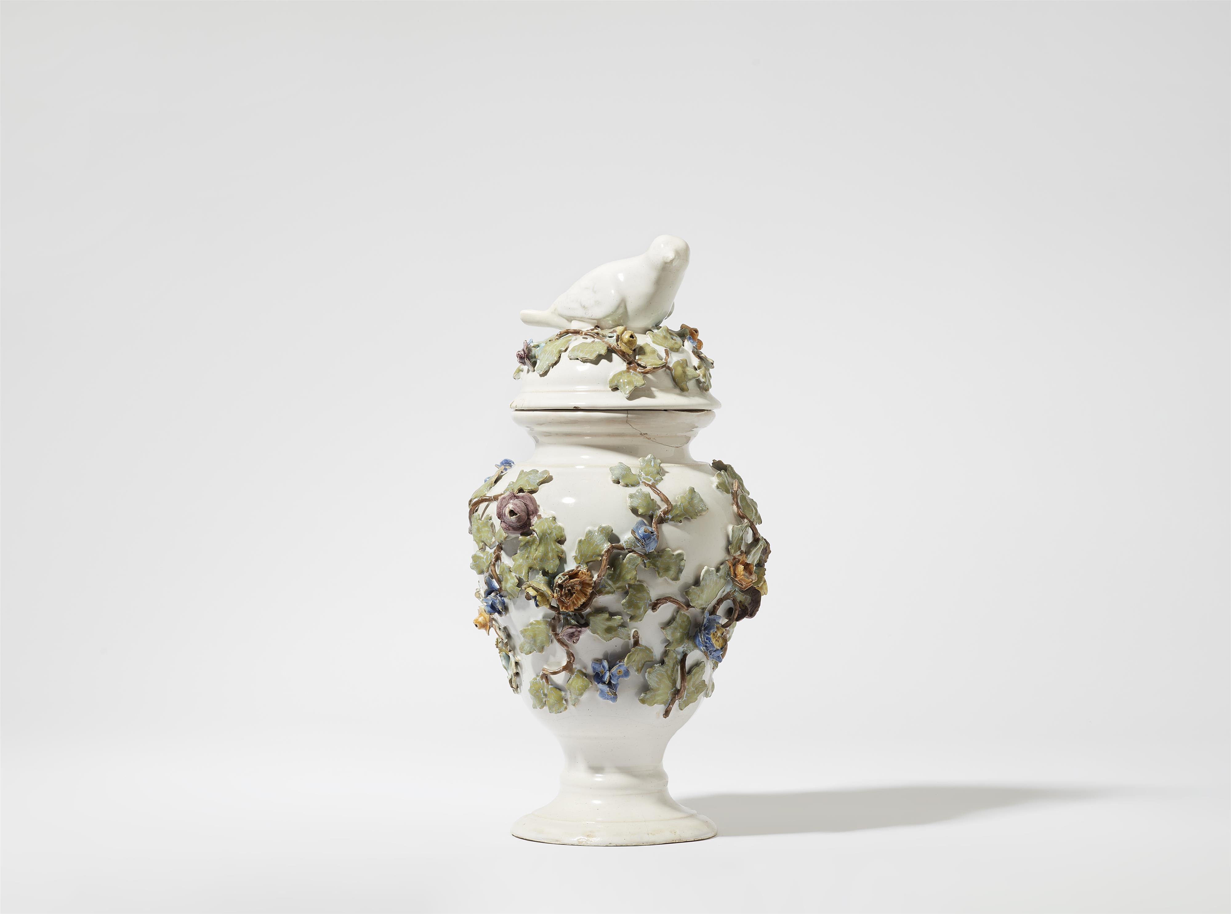 A faience vase with a bird finial - image-1