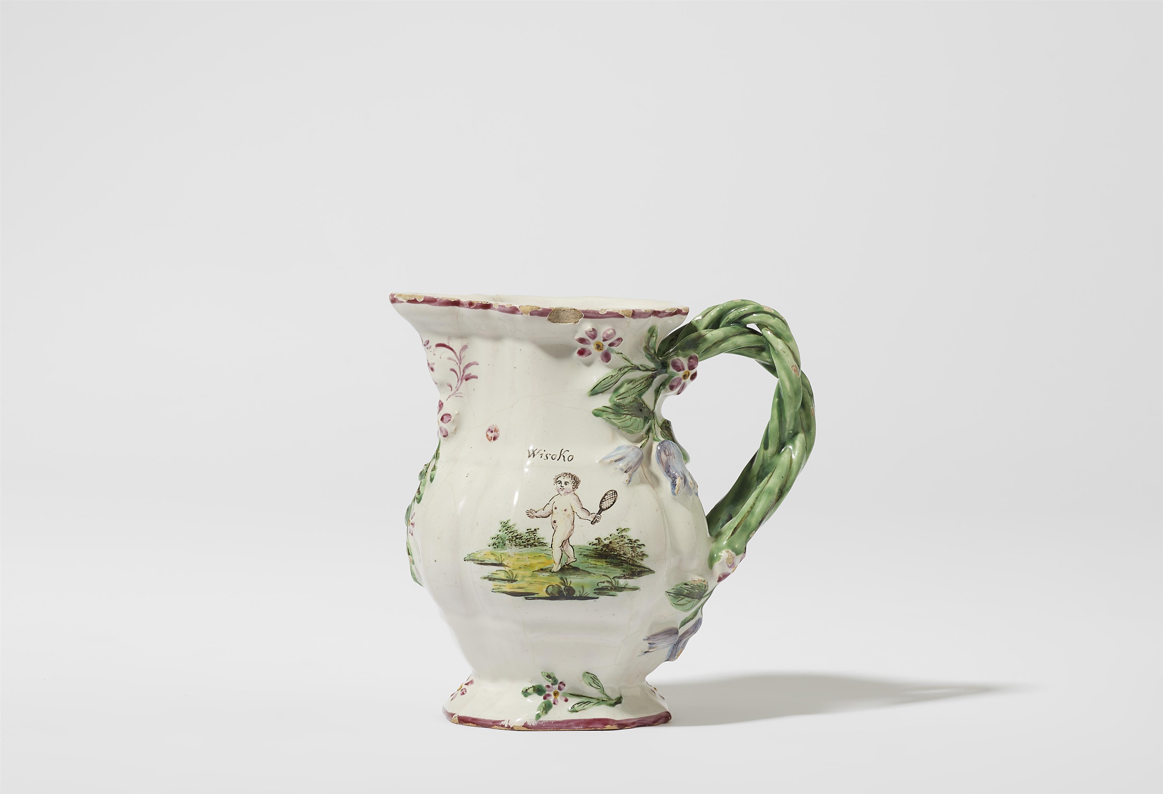 A Proskau faience jug with putti playing tennis - image-1