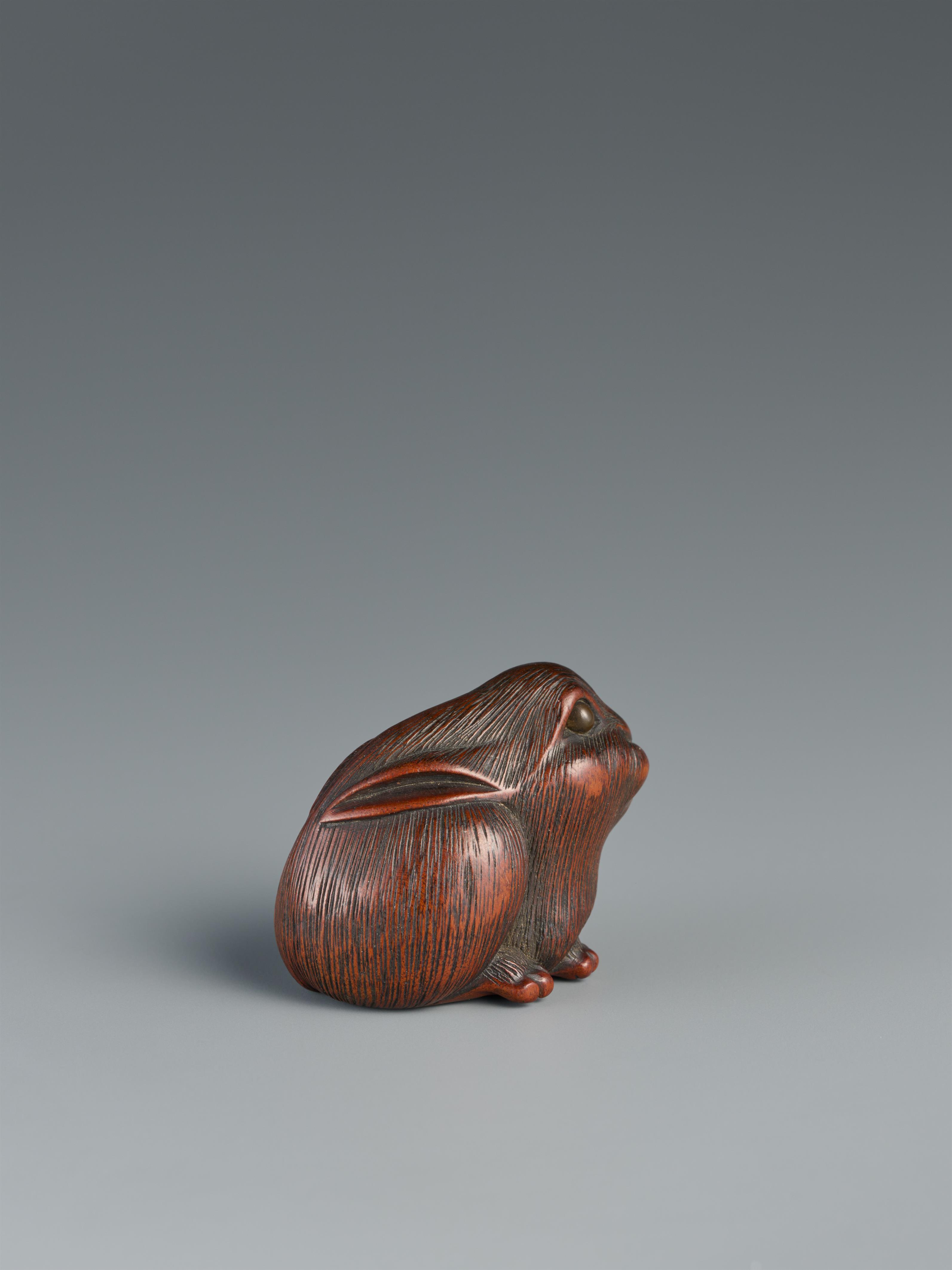 A wood netsuke of seated hare. - image-2
