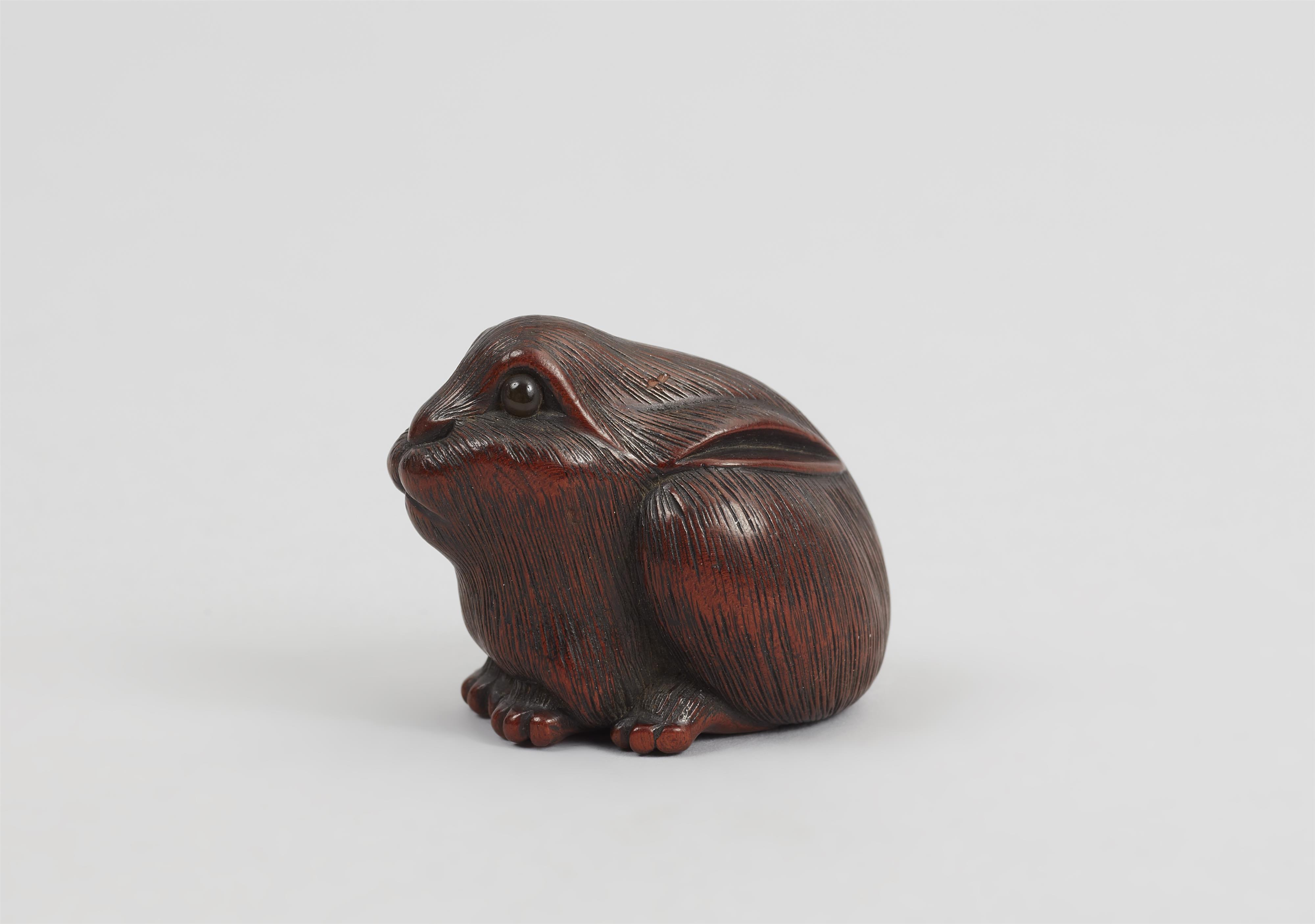 A wood netsuke of seated hare. - image-4