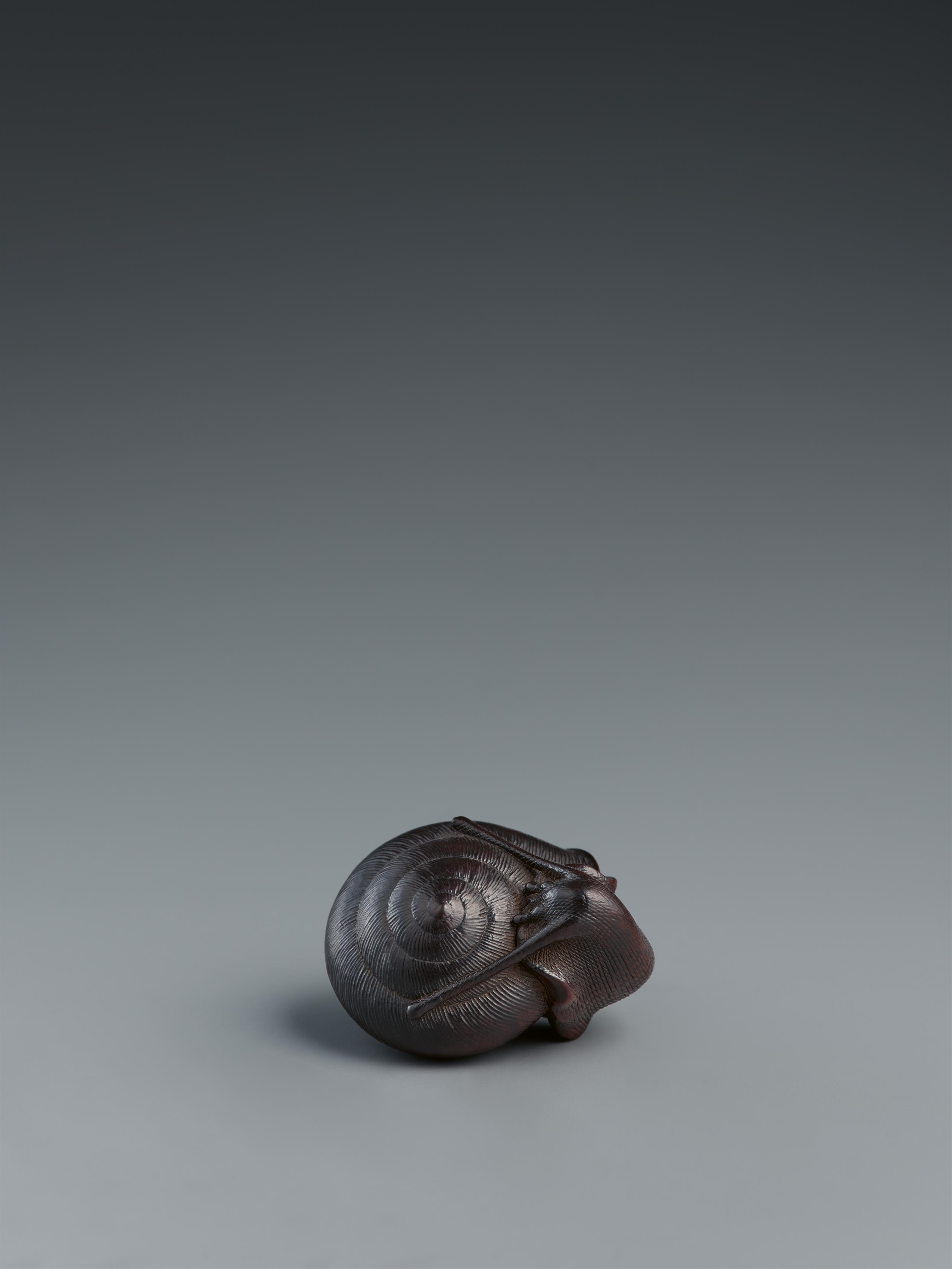 A dark stained boxwood netsuke of a snail. Nagoya. Mid-19th century - image-1
