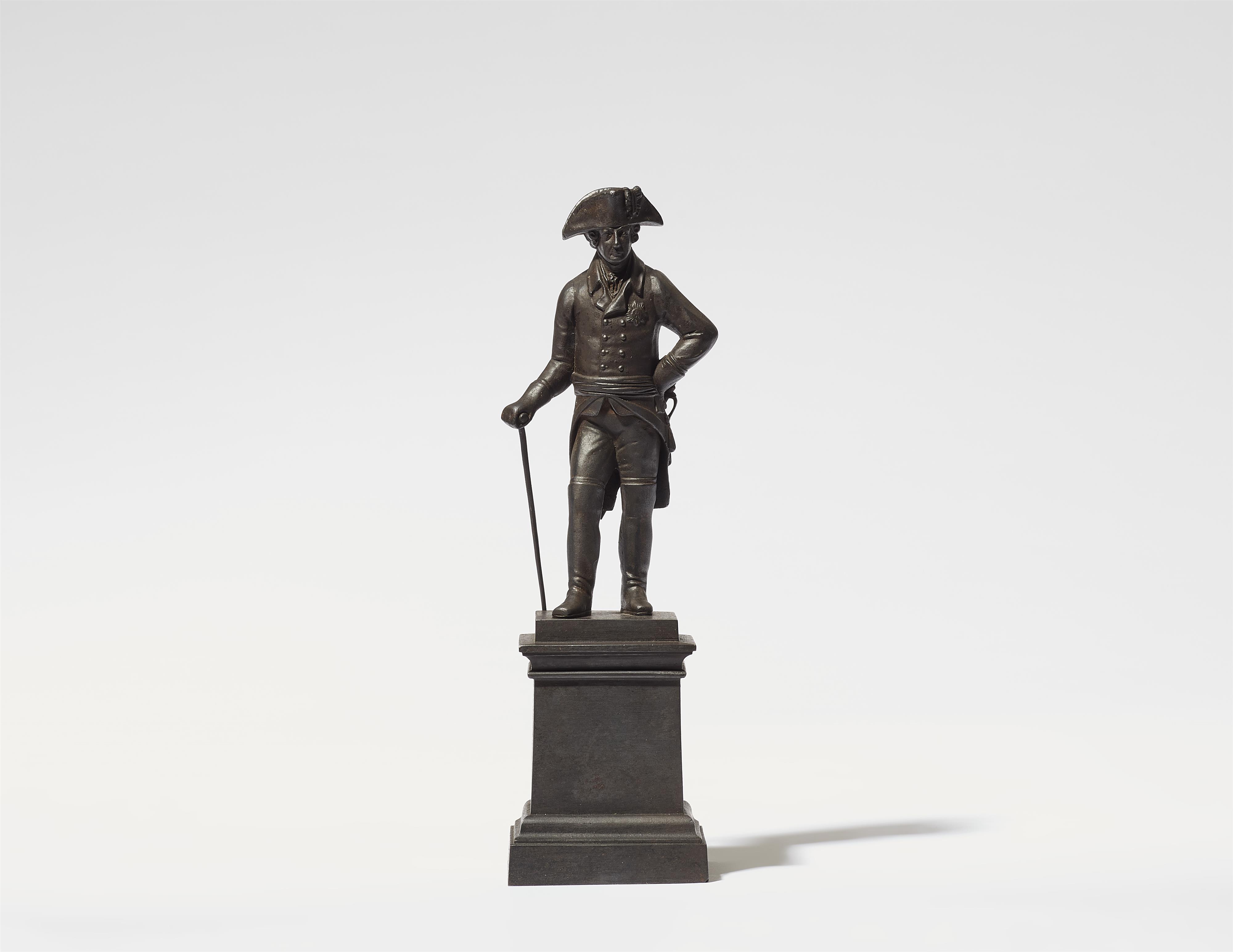 A cast iron statuette of King Friedrich II on a plinth - image-1
