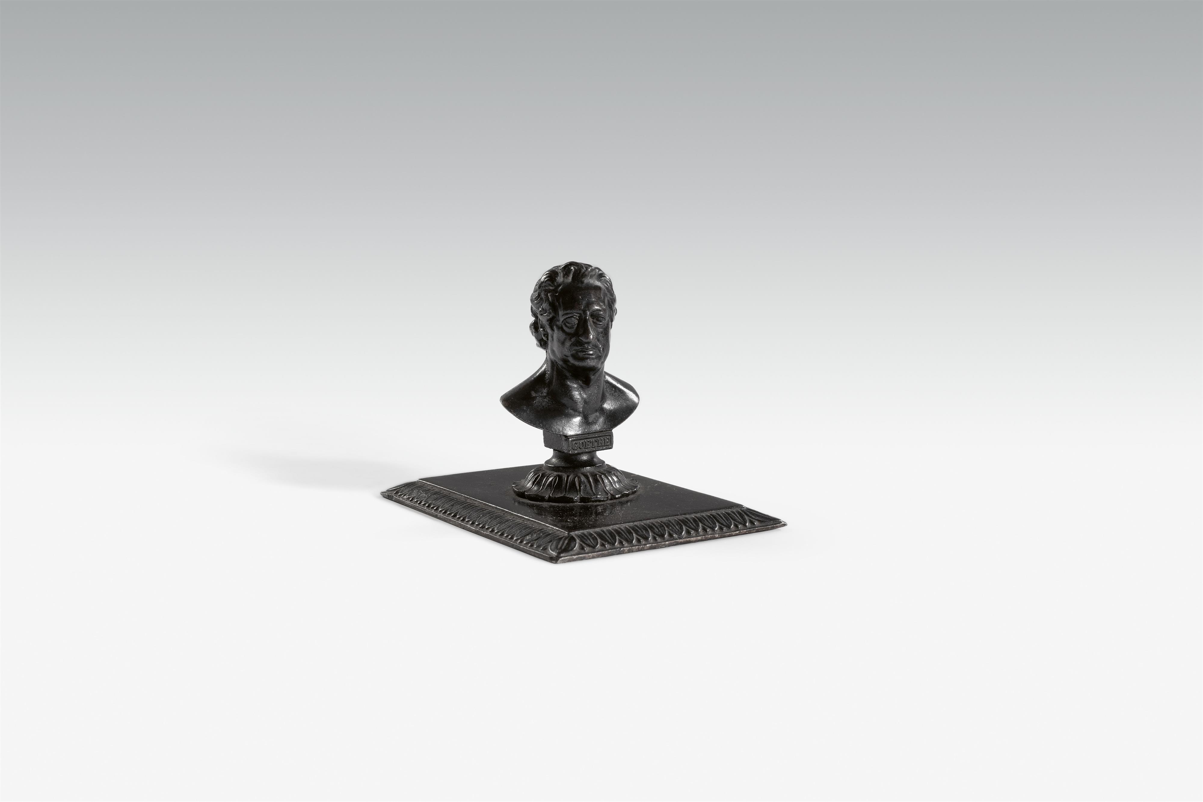 A cast iron paperweight with a bust of Goethe - image-1