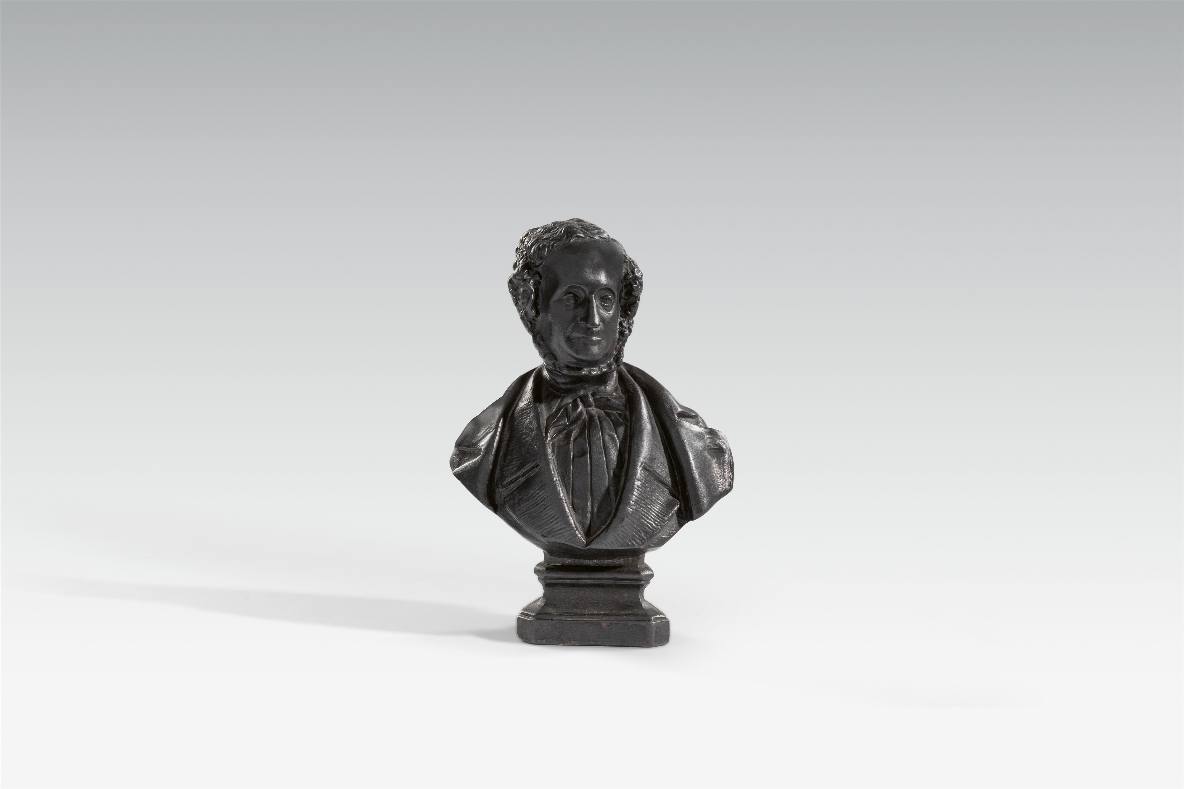 A cast iron bust of a gentleman with sideburns - image-1
