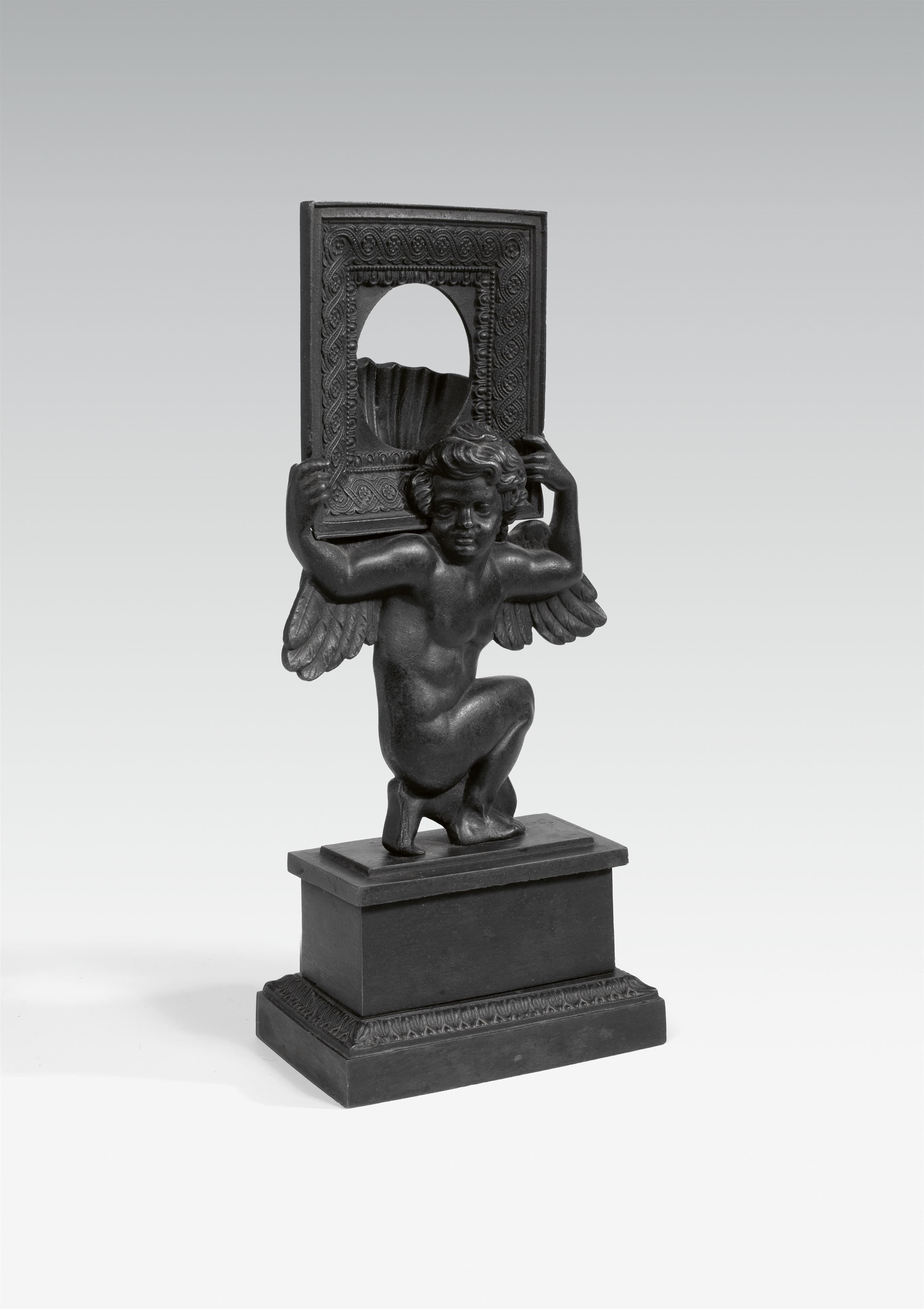 A cast iron portremontre with a putto and frame - image-1
