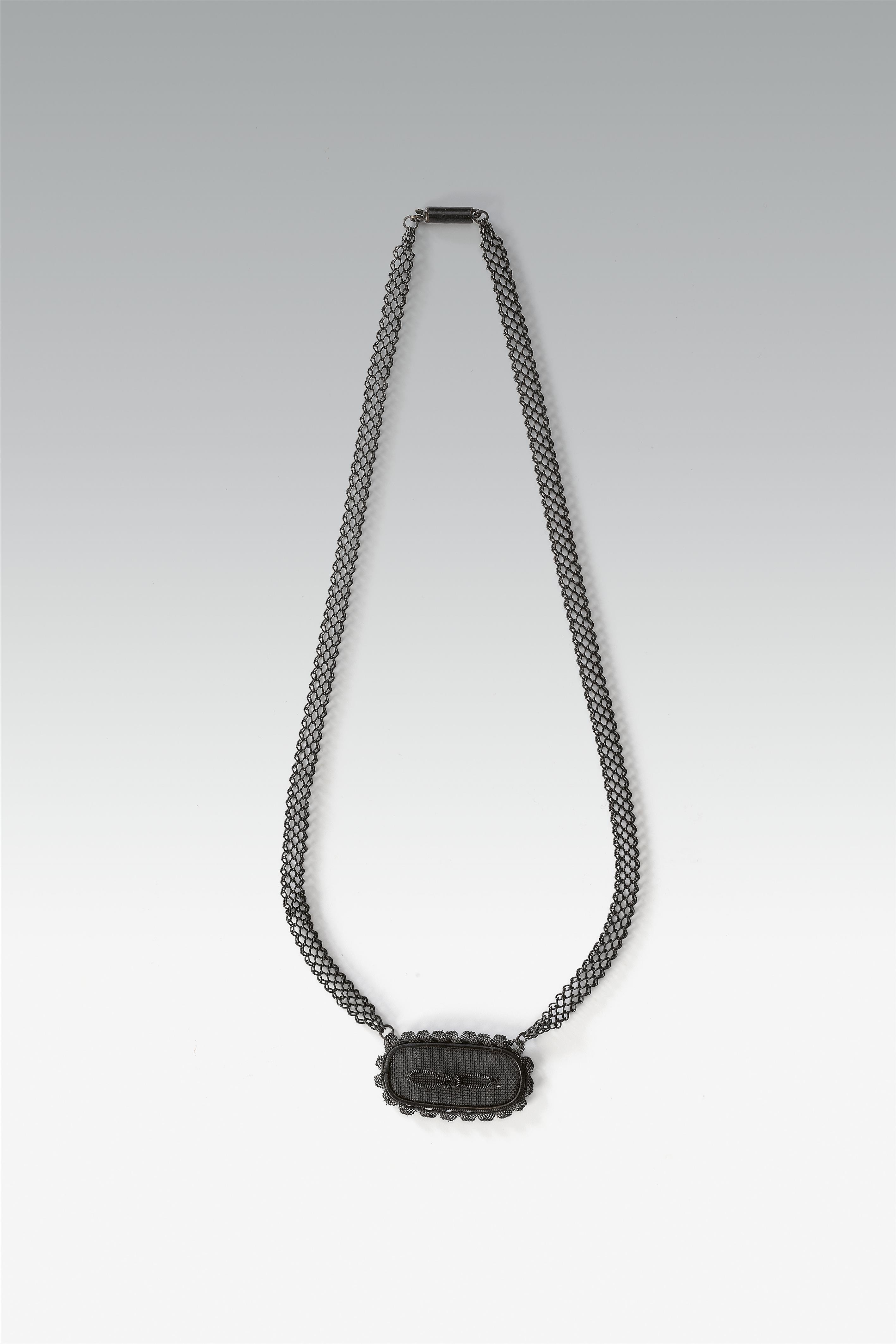 A cast iron pendant necklace with braided iron wire - image-1