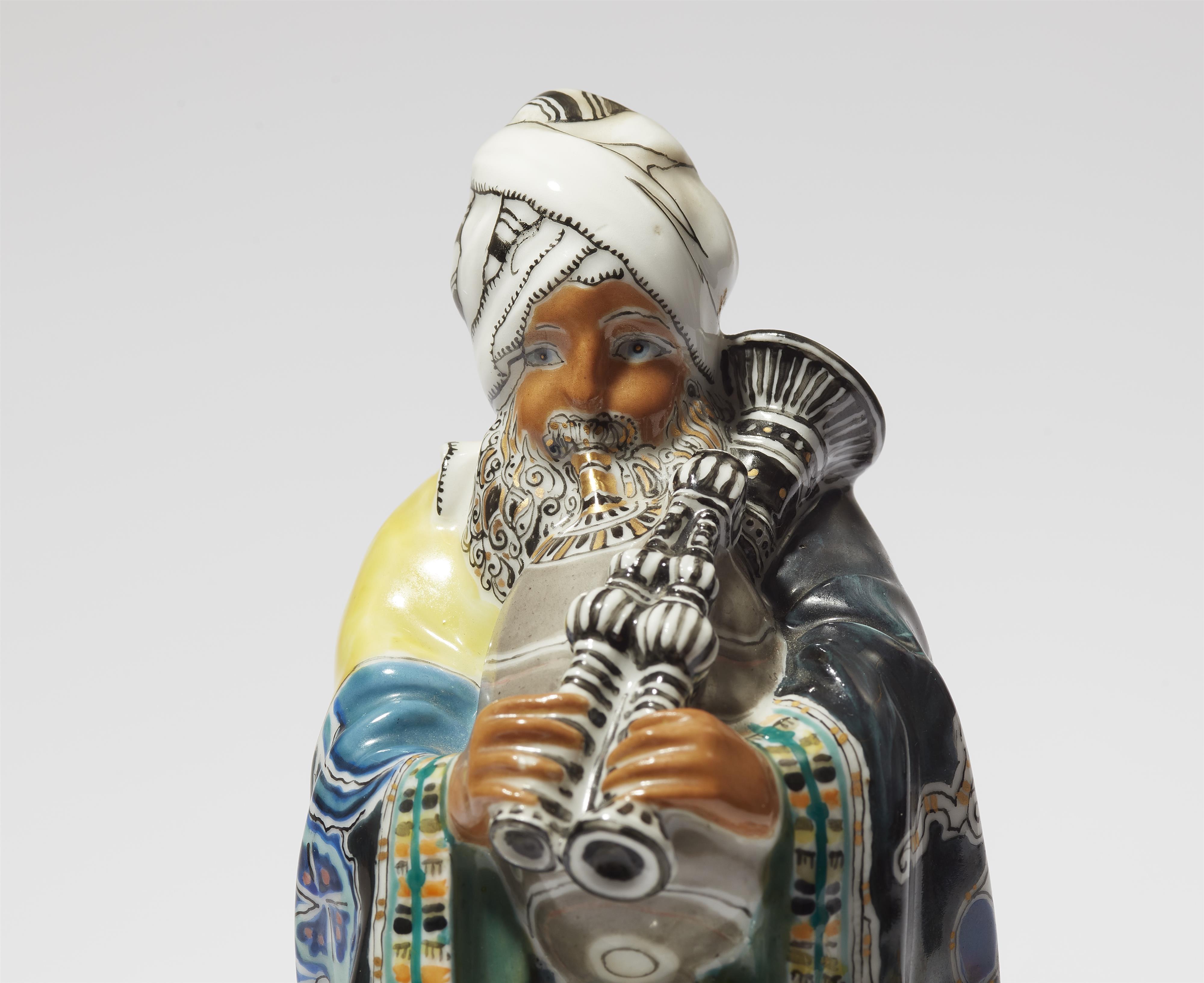 A Berlin KPM porcelain model of a bagpipe player from the "Indischer Festzug" centrepiece - image-2