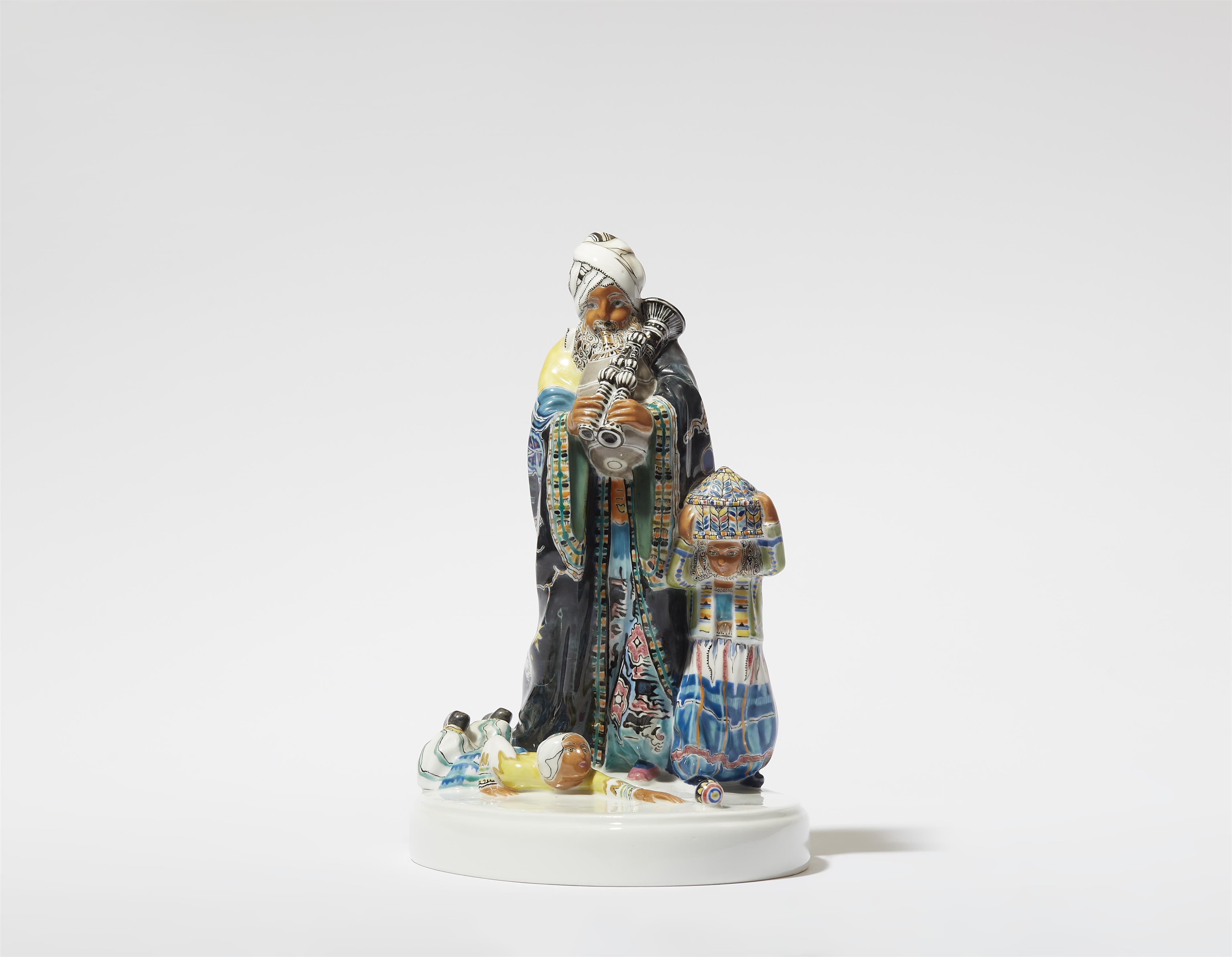 A Berlin KPM porcelain model of a bagpipe player from the "Indischer Festzug" centrepiece - image-1