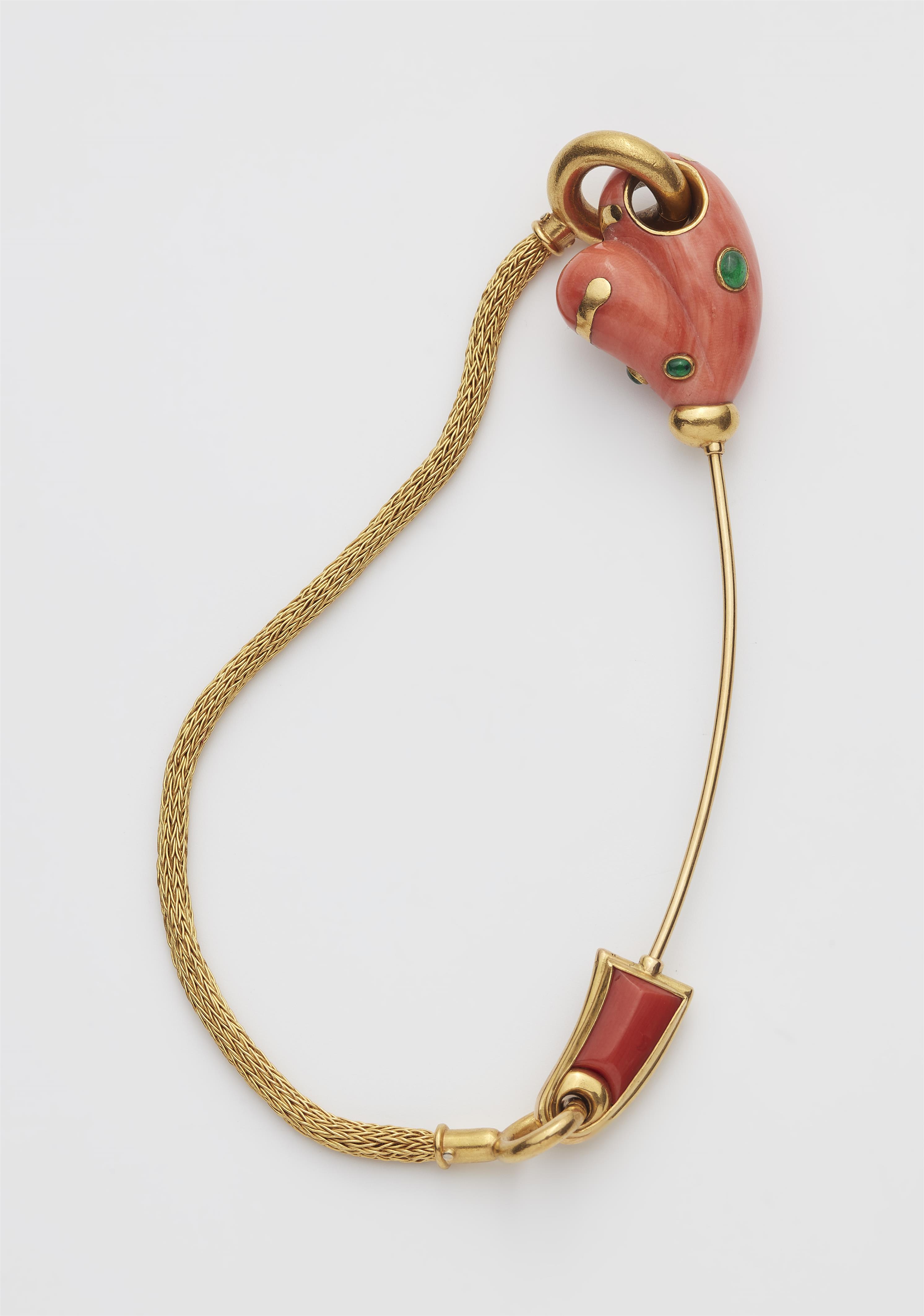 A German18k gold and carved red coral and emerald pin with meshwork connecting chain. - image-1