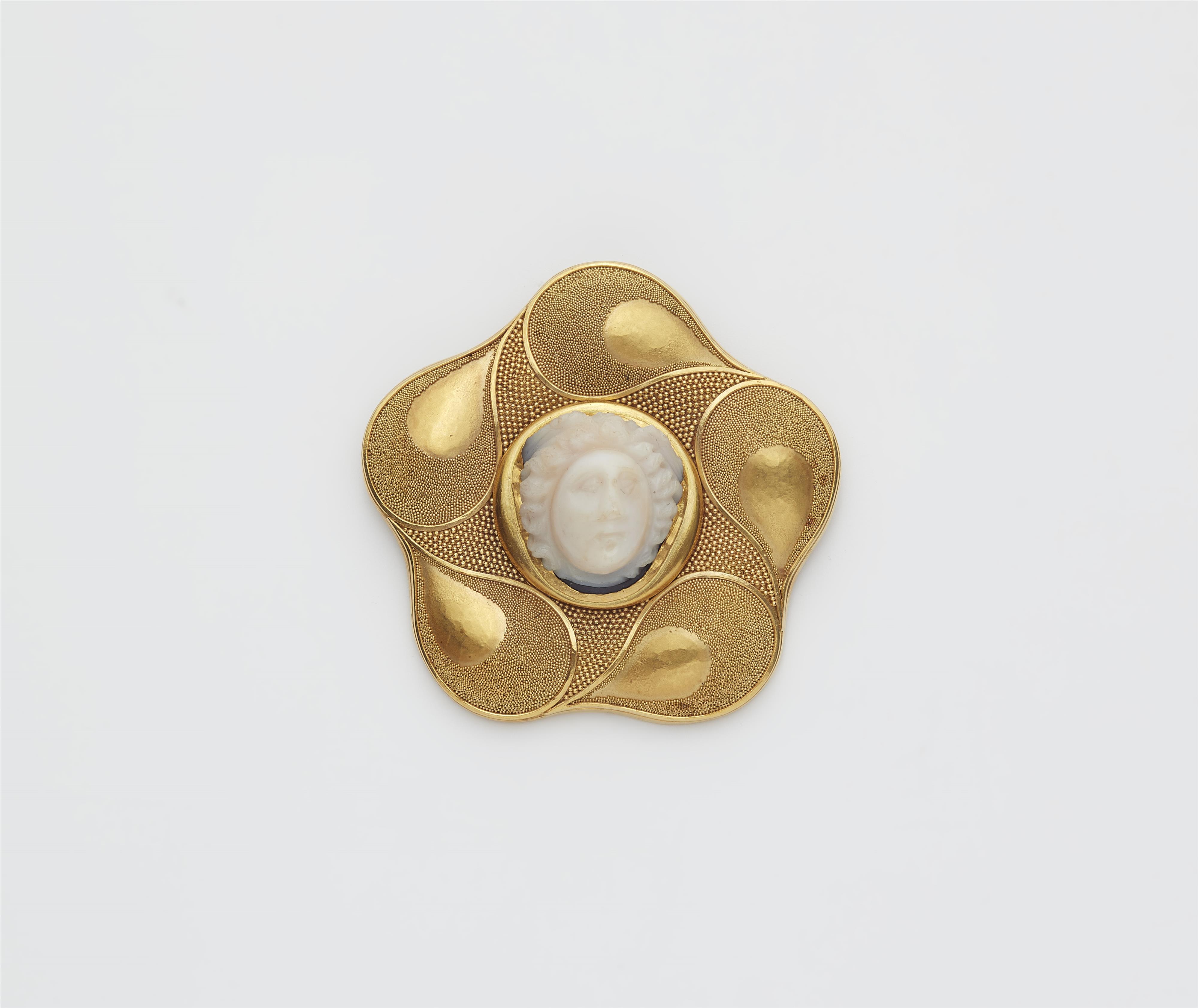 A German 18/21k gold and granulation brooch with an ancient Roman layered onyx cameo of a Medusa head. - image-1