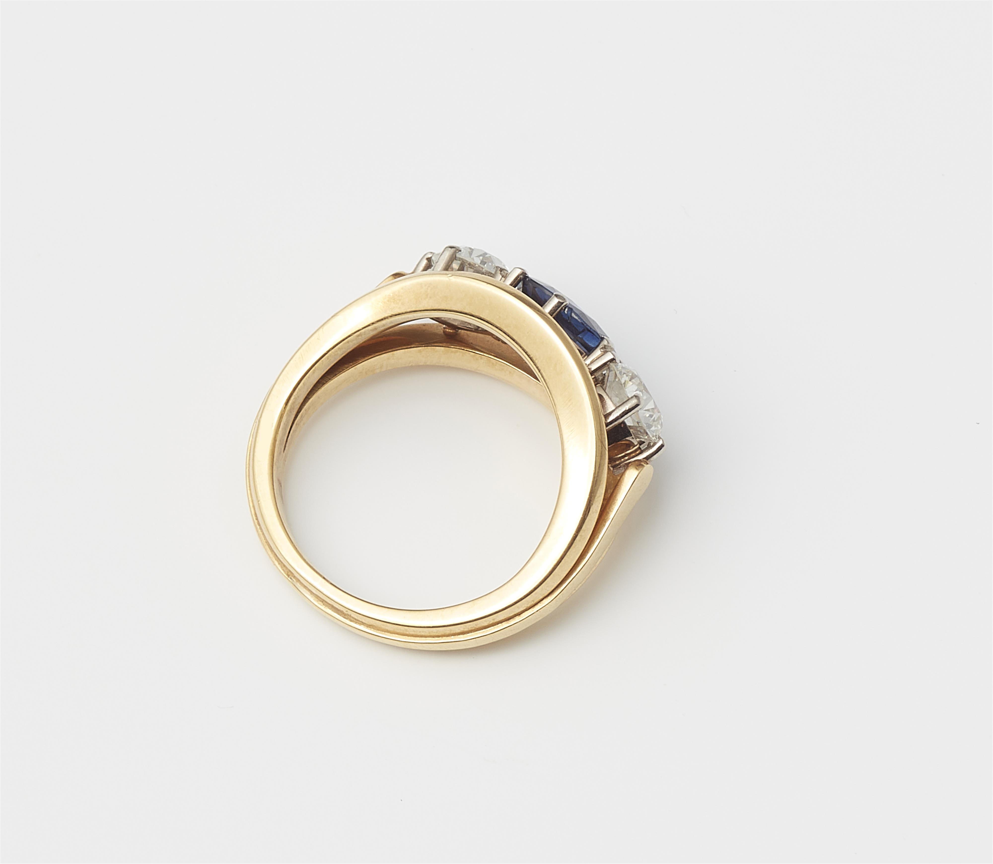 A German18 kt yellow gold diamond and sapphire three stone ring. - image-2