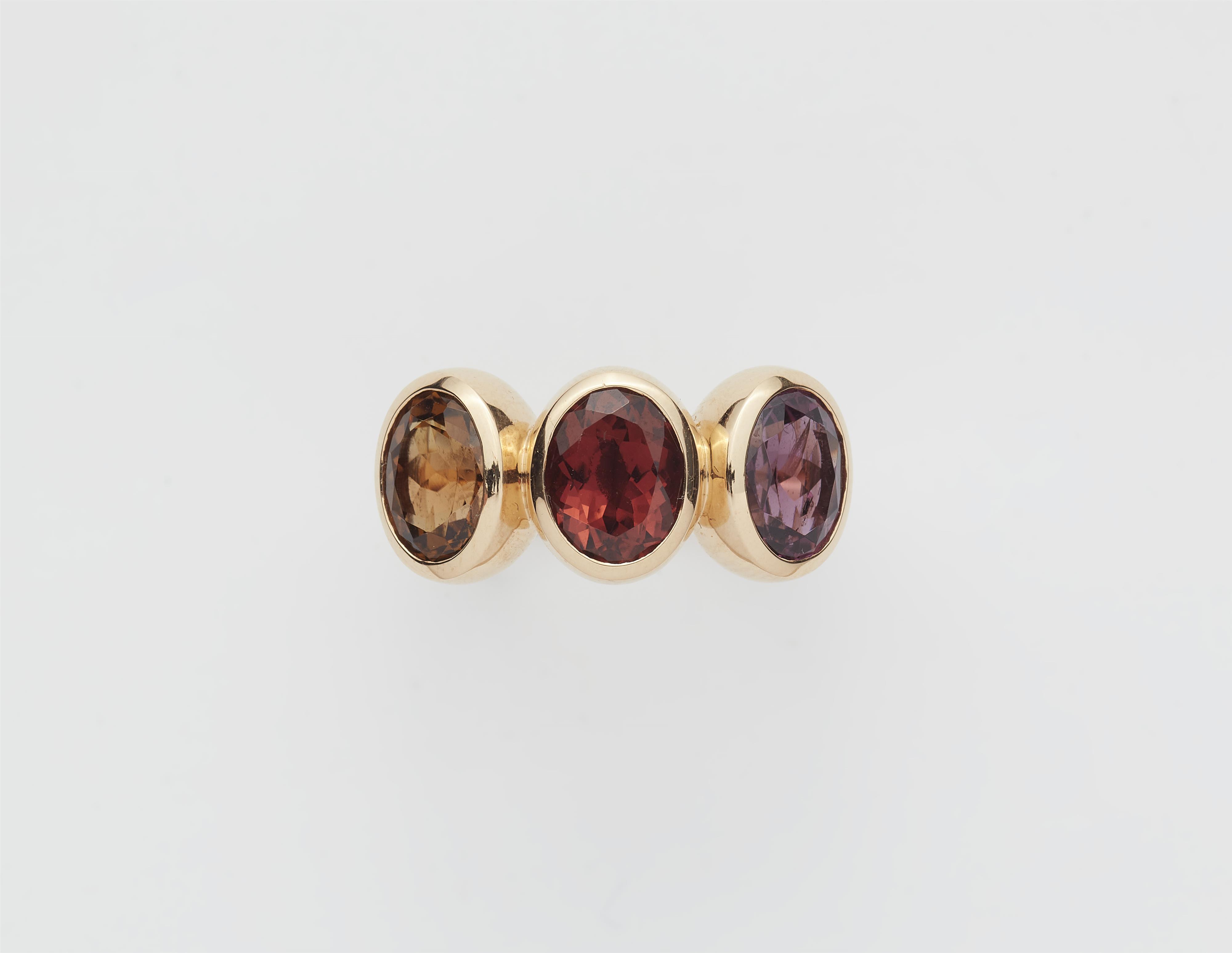 A German 18k gold and coloured tourmaline three stone ring. - image-1