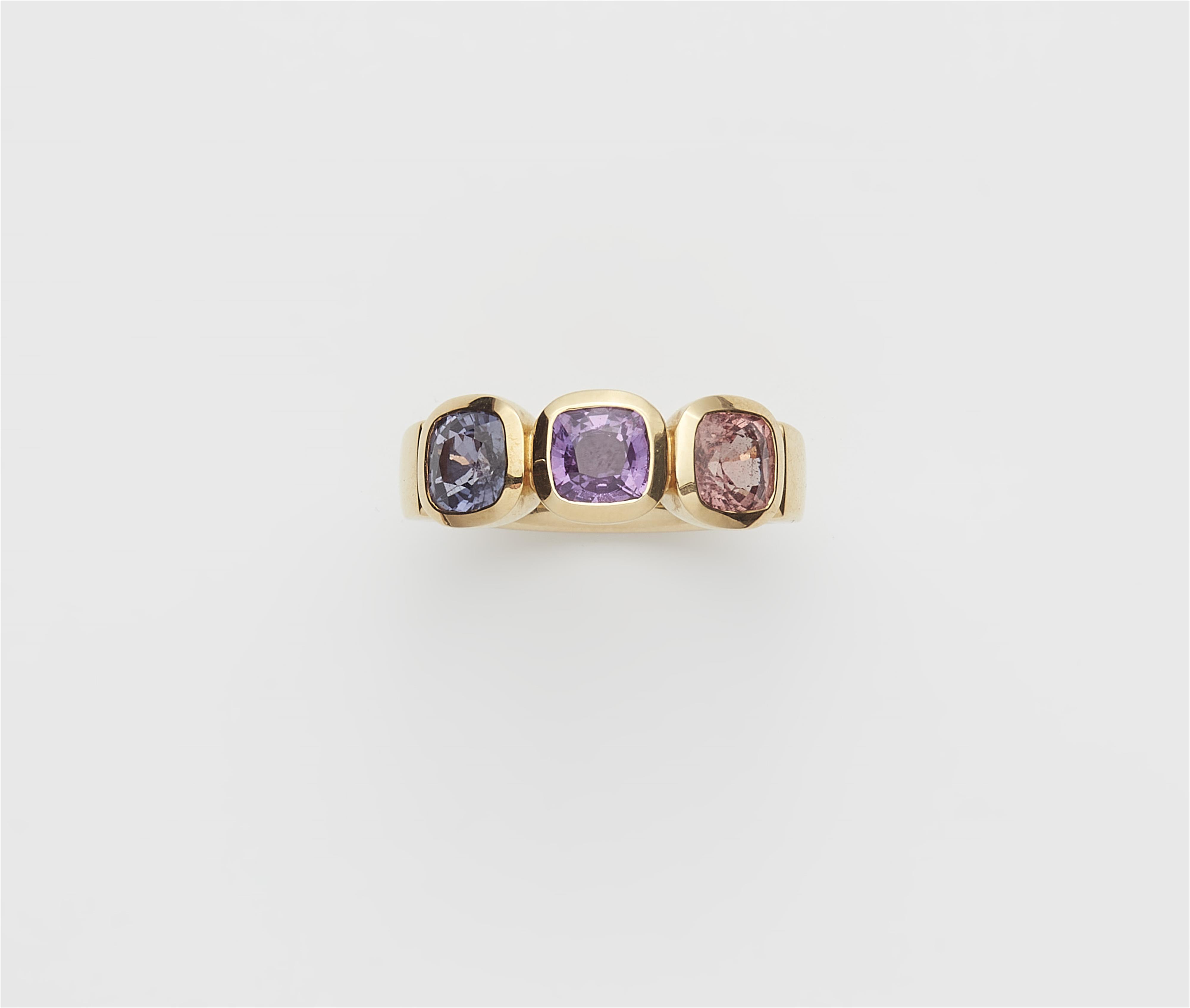 A German 18k gold and coloured sapphire three stone ring. - image-1