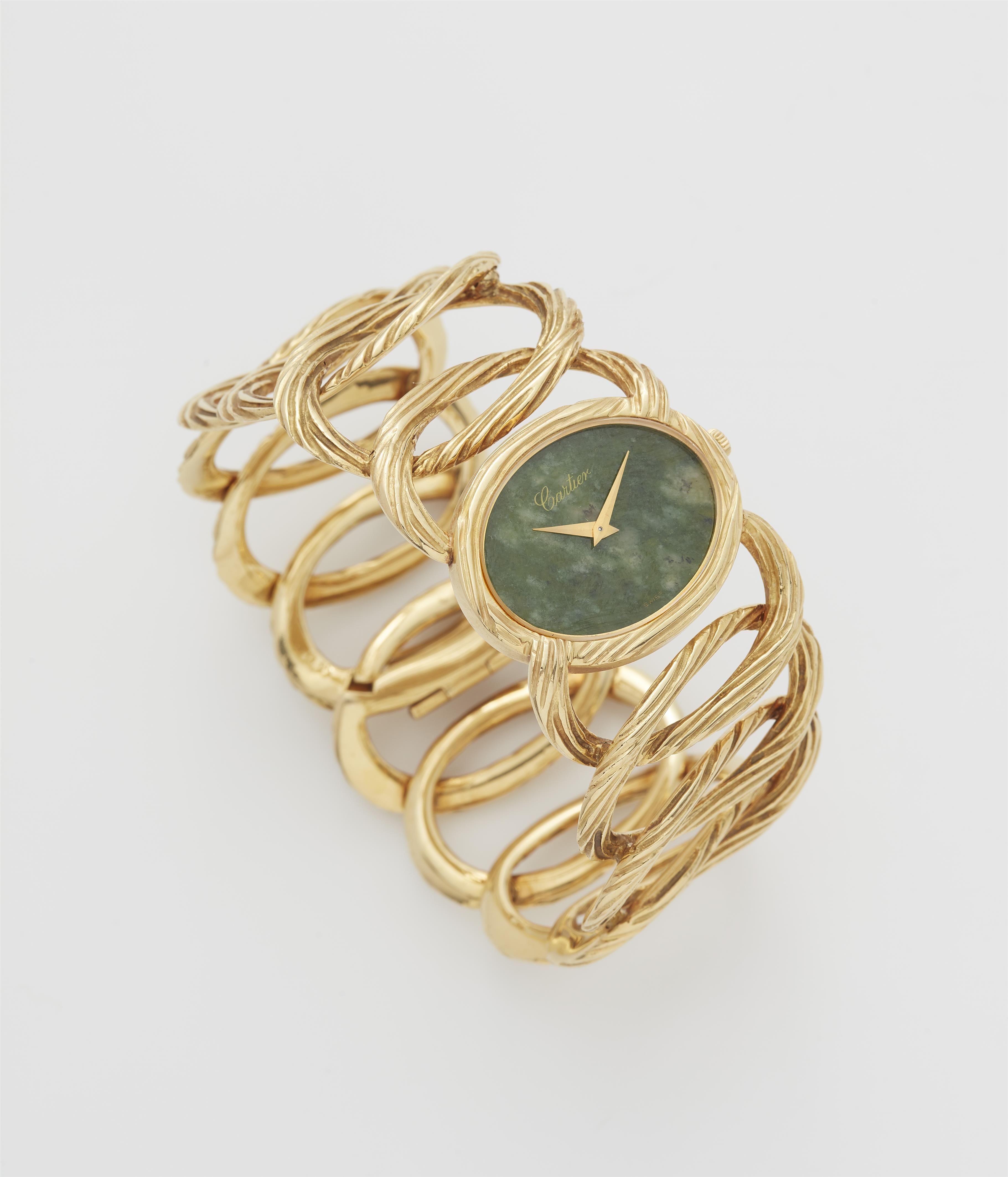 An 18k yellow gold and mottled green nephrite jade ladies' Piaget cuff wristwatch retailed by Cartier. - image-1