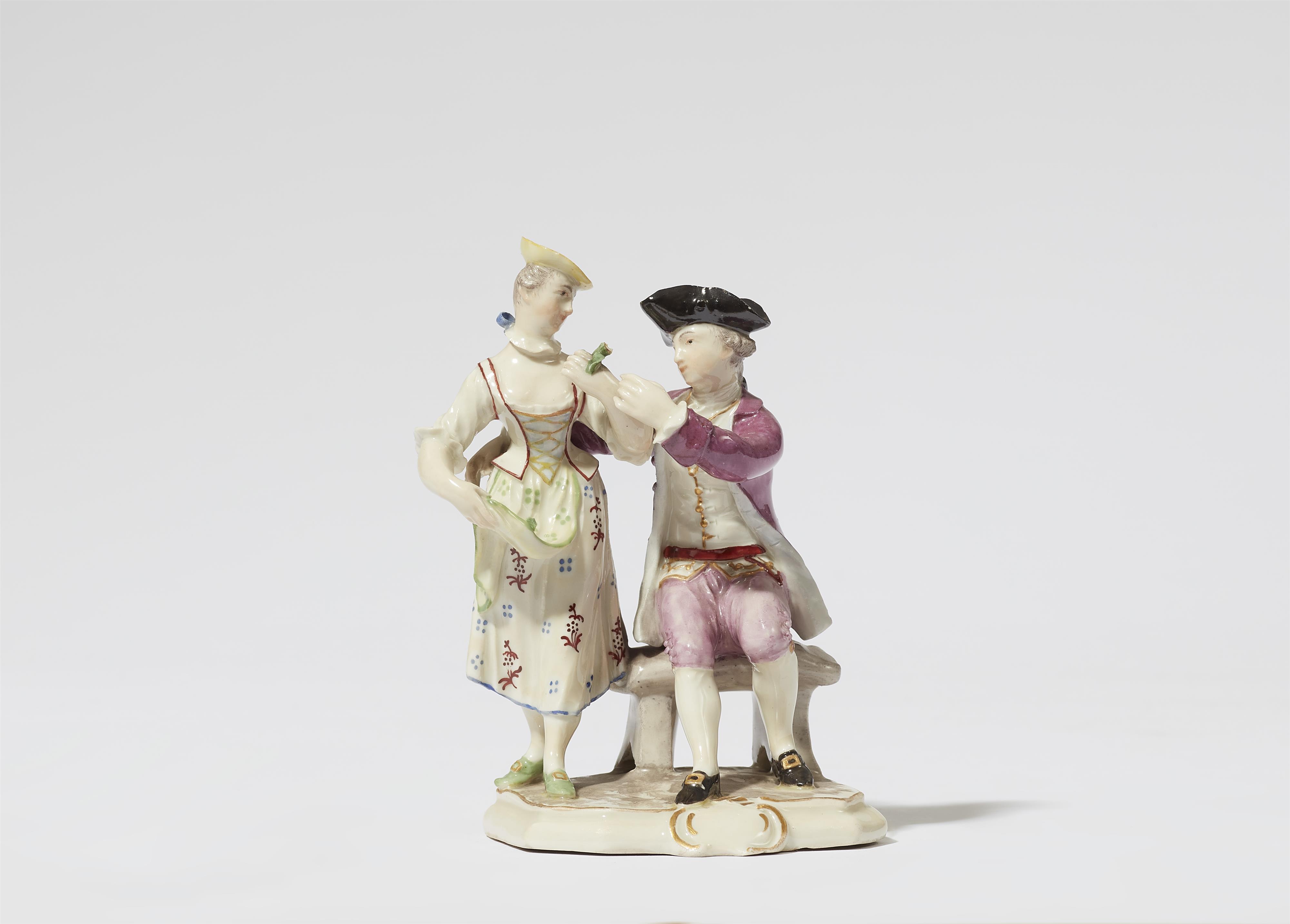 A Ludwigsburg porcelain group of a cavalier offering a flower to a lady - image-1