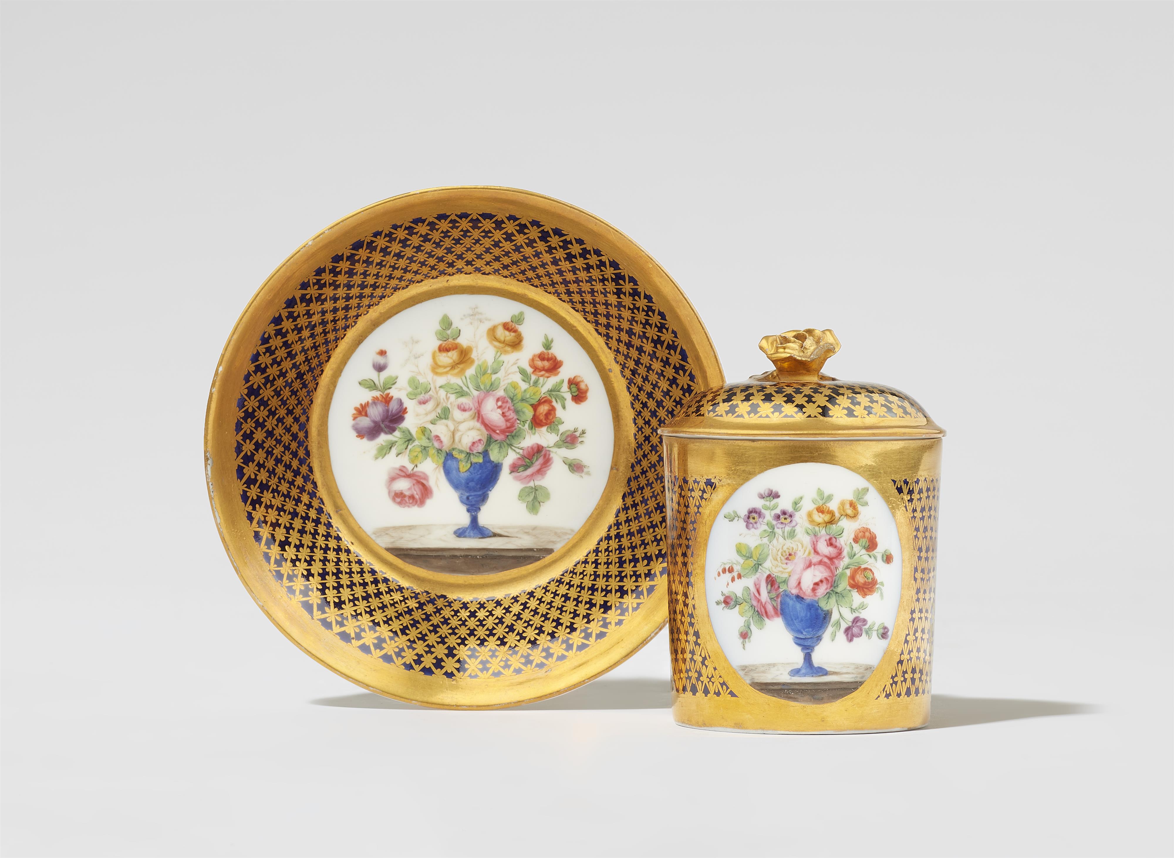 A Parisian porcelain lidded cup and saucer with vases of flowers - image-1