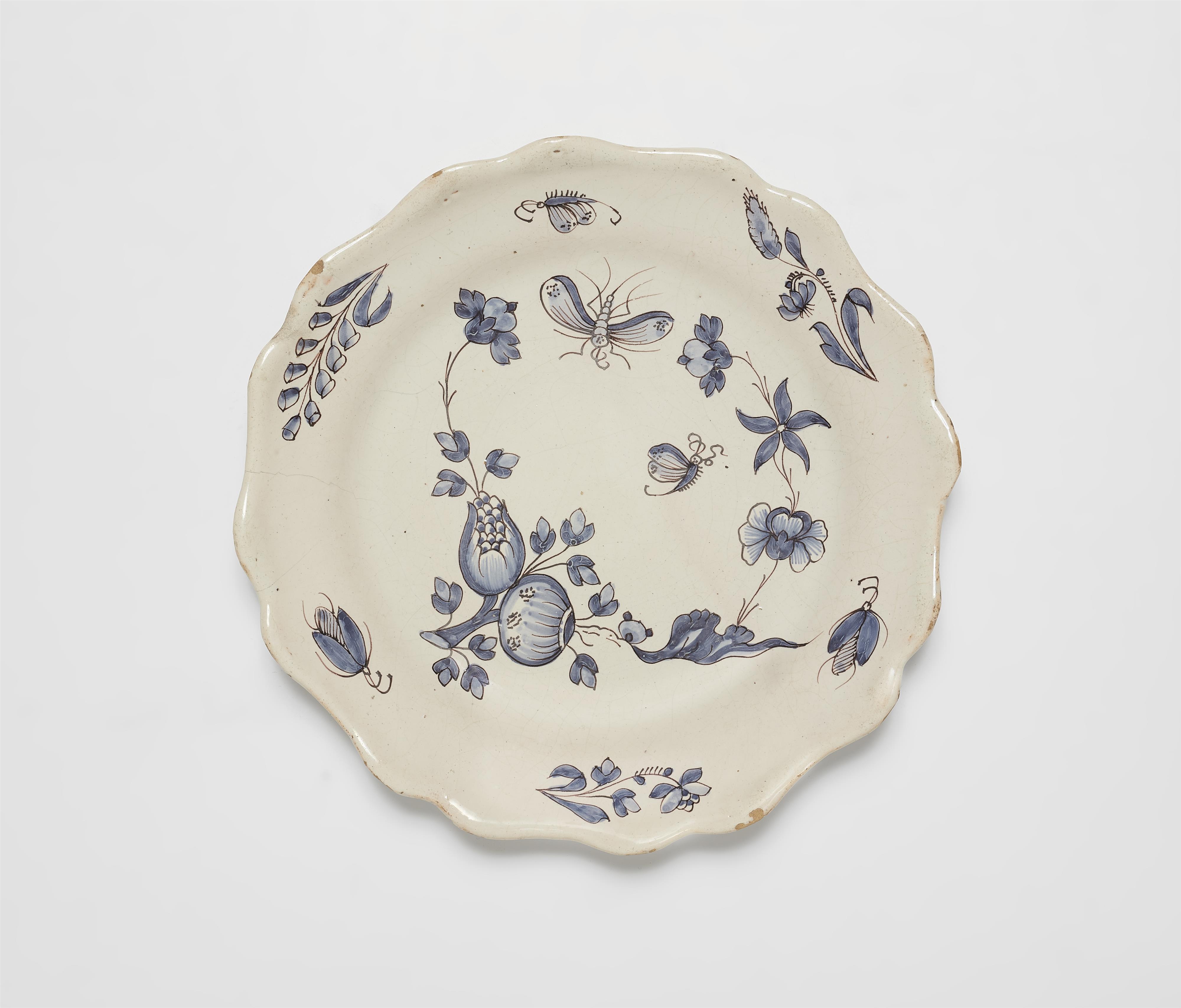 A French faience plate with "fleurs contournées" and insect motifs - image-1