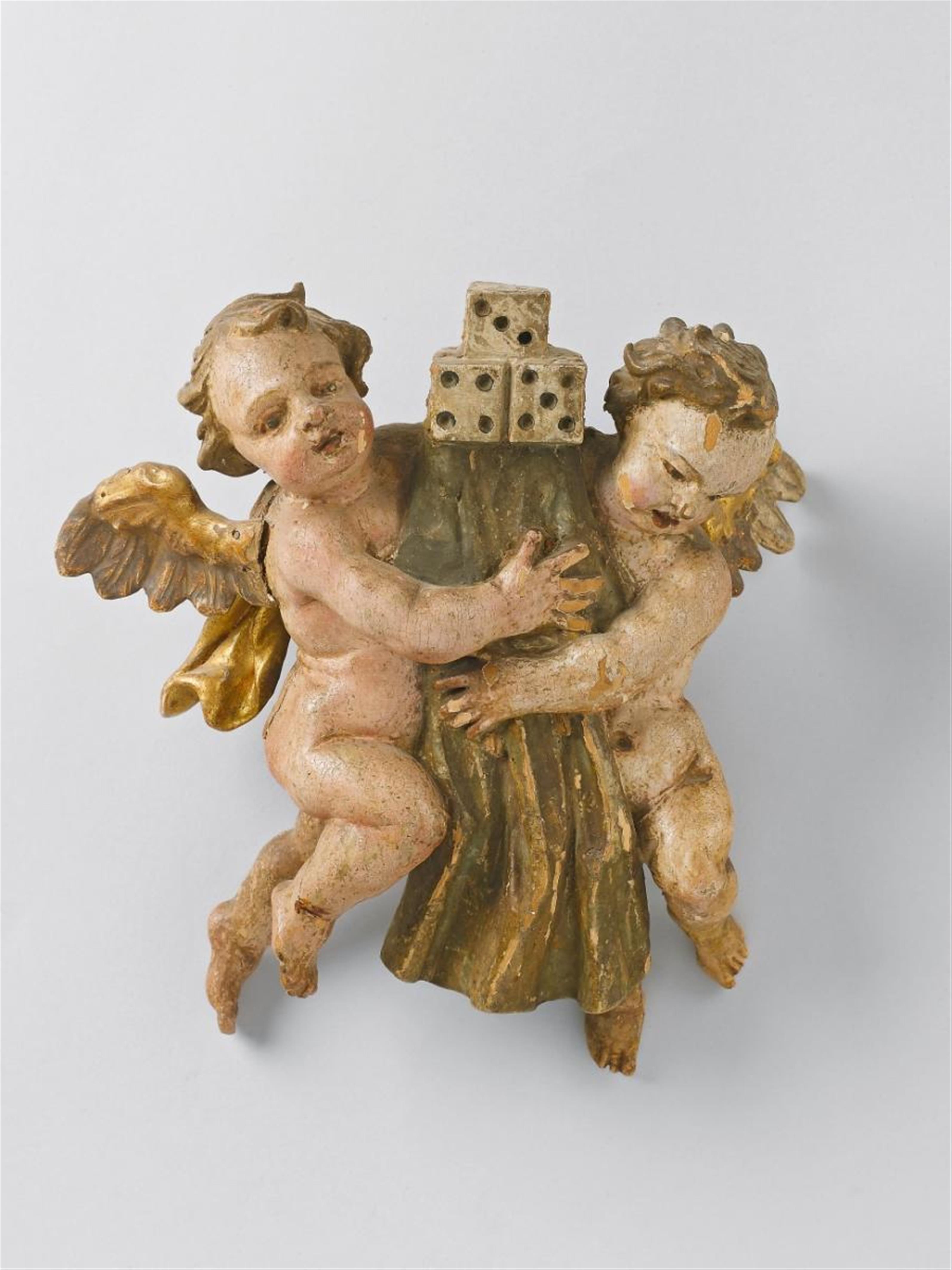 A carved and polychrome wood relief of TWO ANGELS WITH THE ARMA CHRISTI - image-1