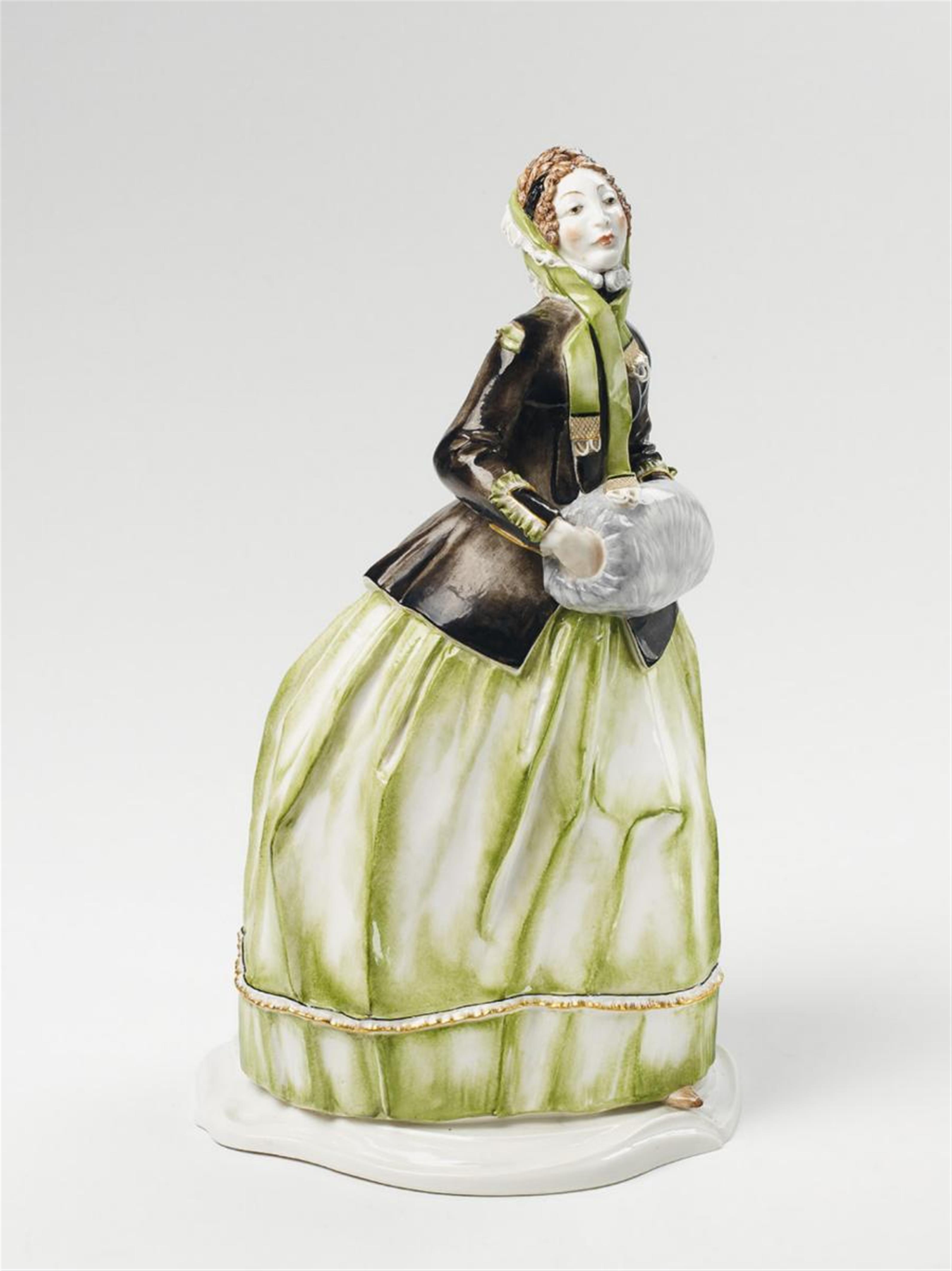 A Nymphenburg figure of a lady in a muffler, - 