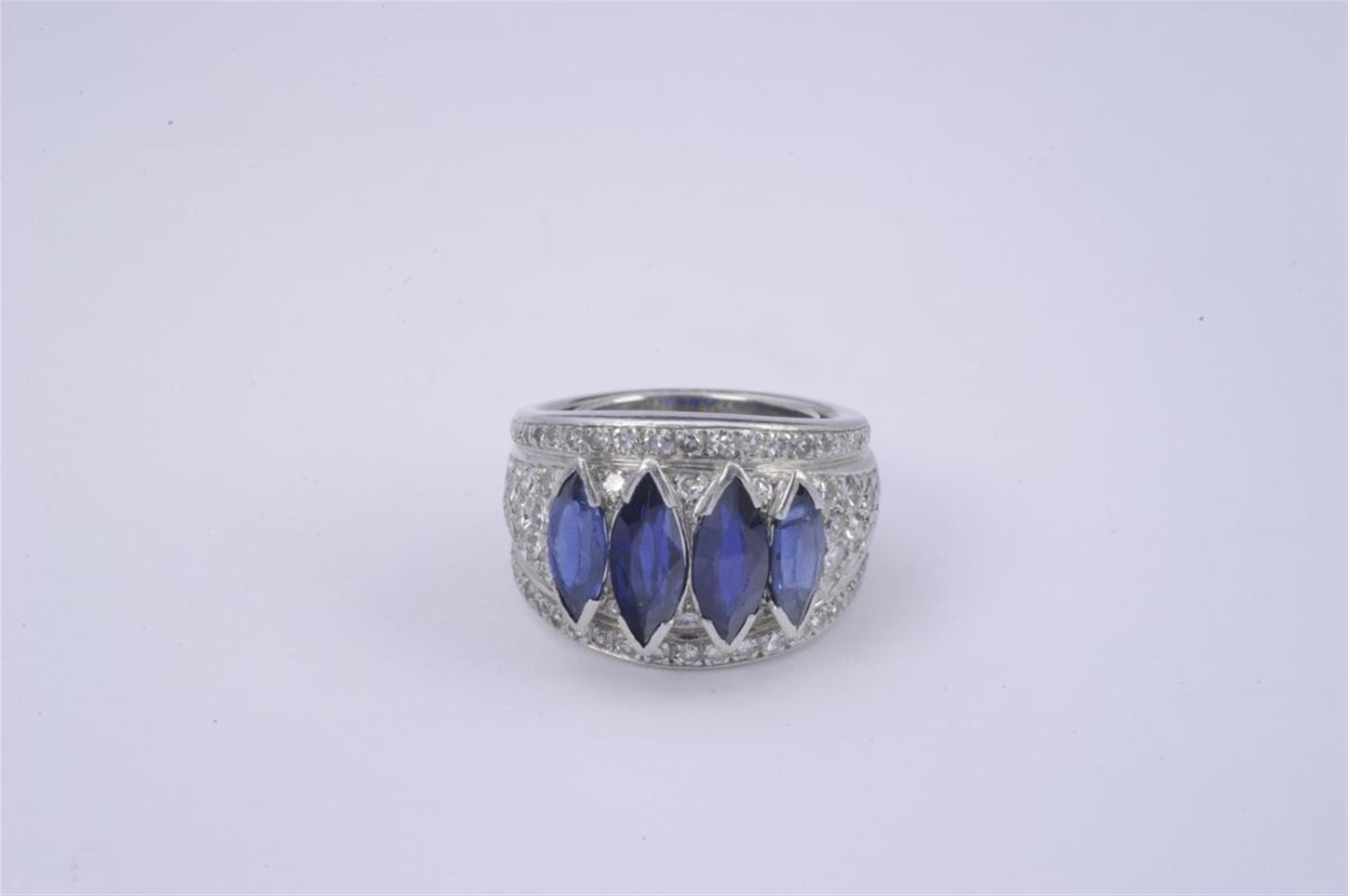 A platinum ring set with sapphires. - image-1