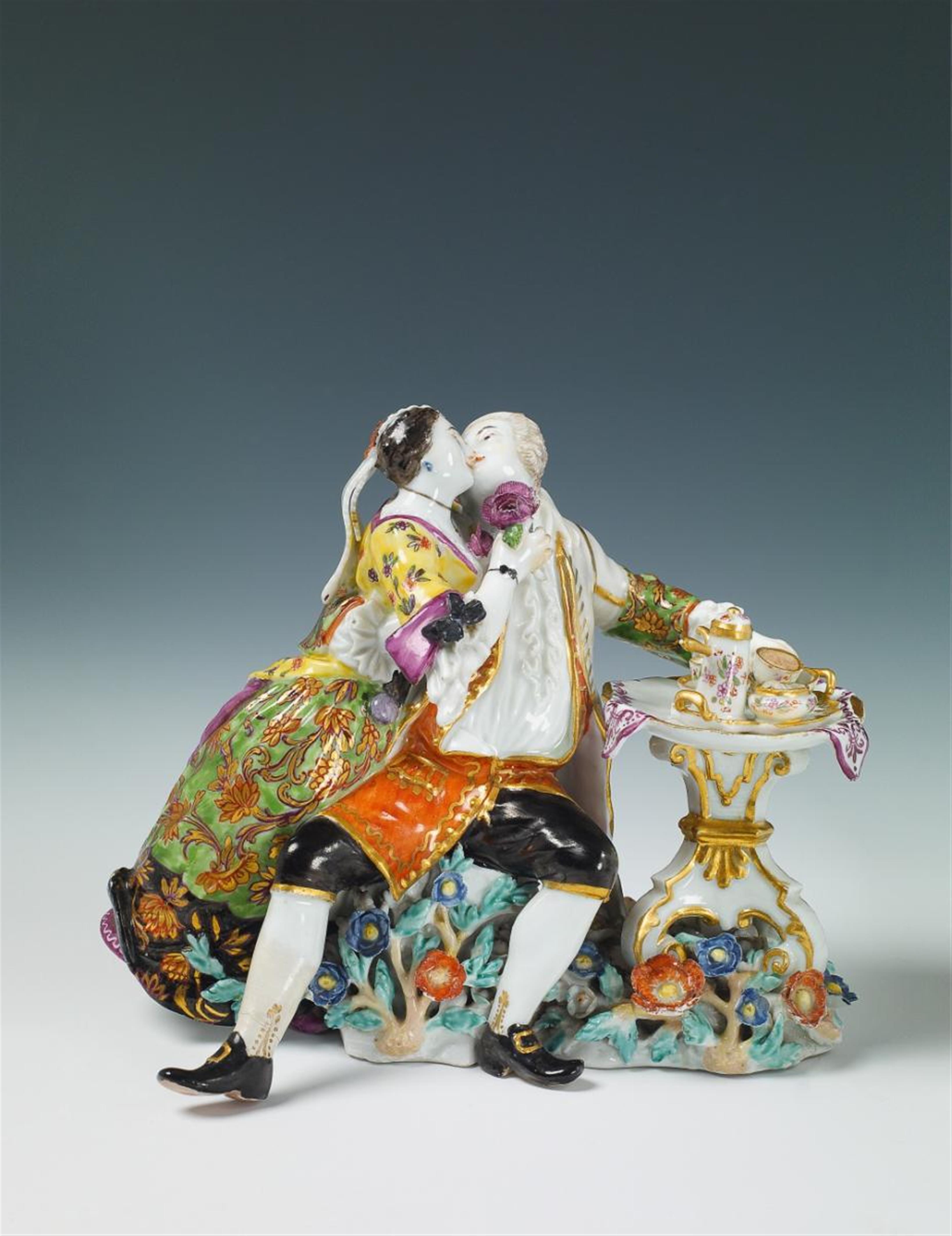 A rare Meissen group showing a finely dressed couple enjoying hot chocolate at a table on a floral base. Liebespaar bei der Schokolade - 