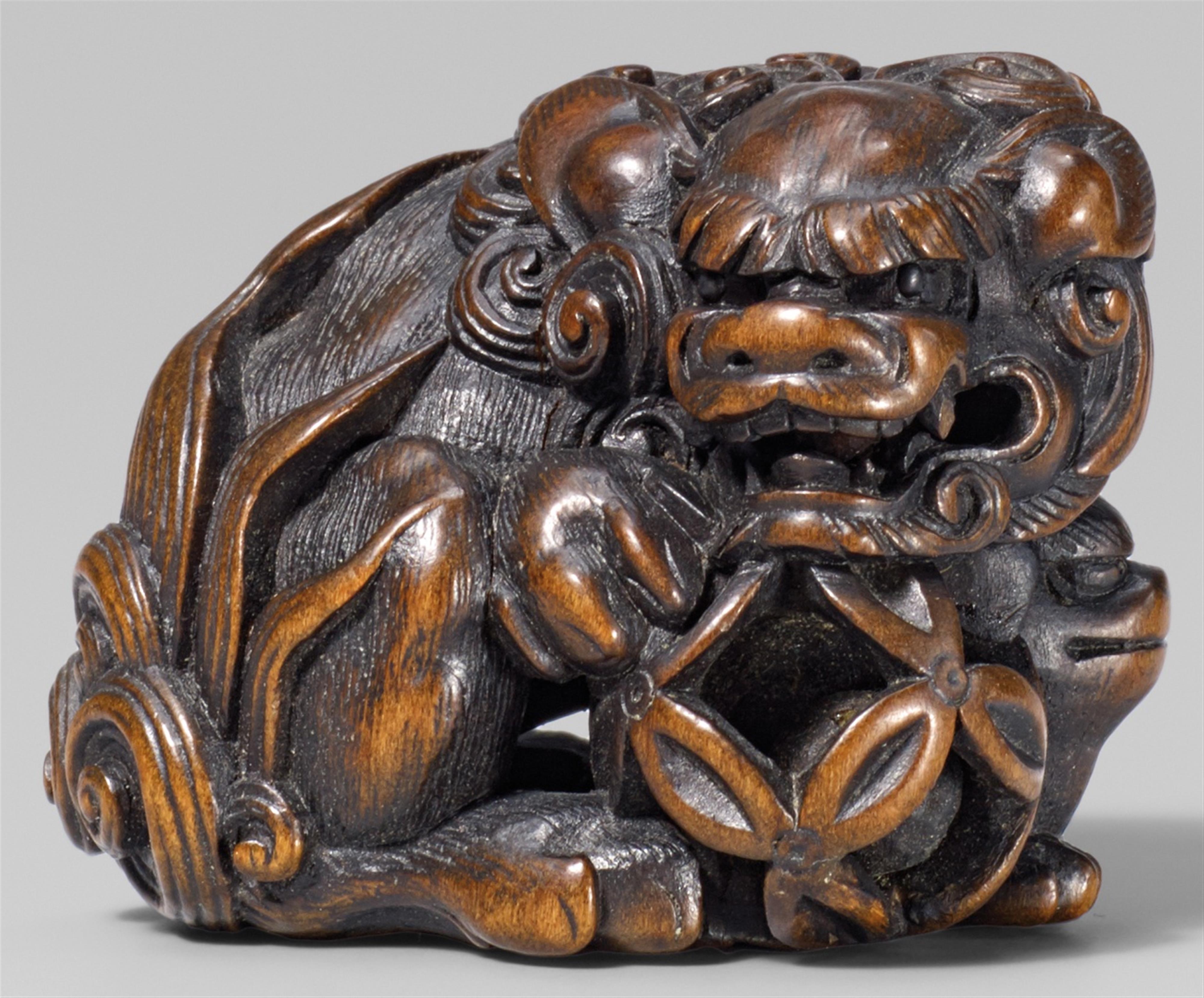 A fine boxwood netsuke of a shishi and young. Mid 19th century - image-1