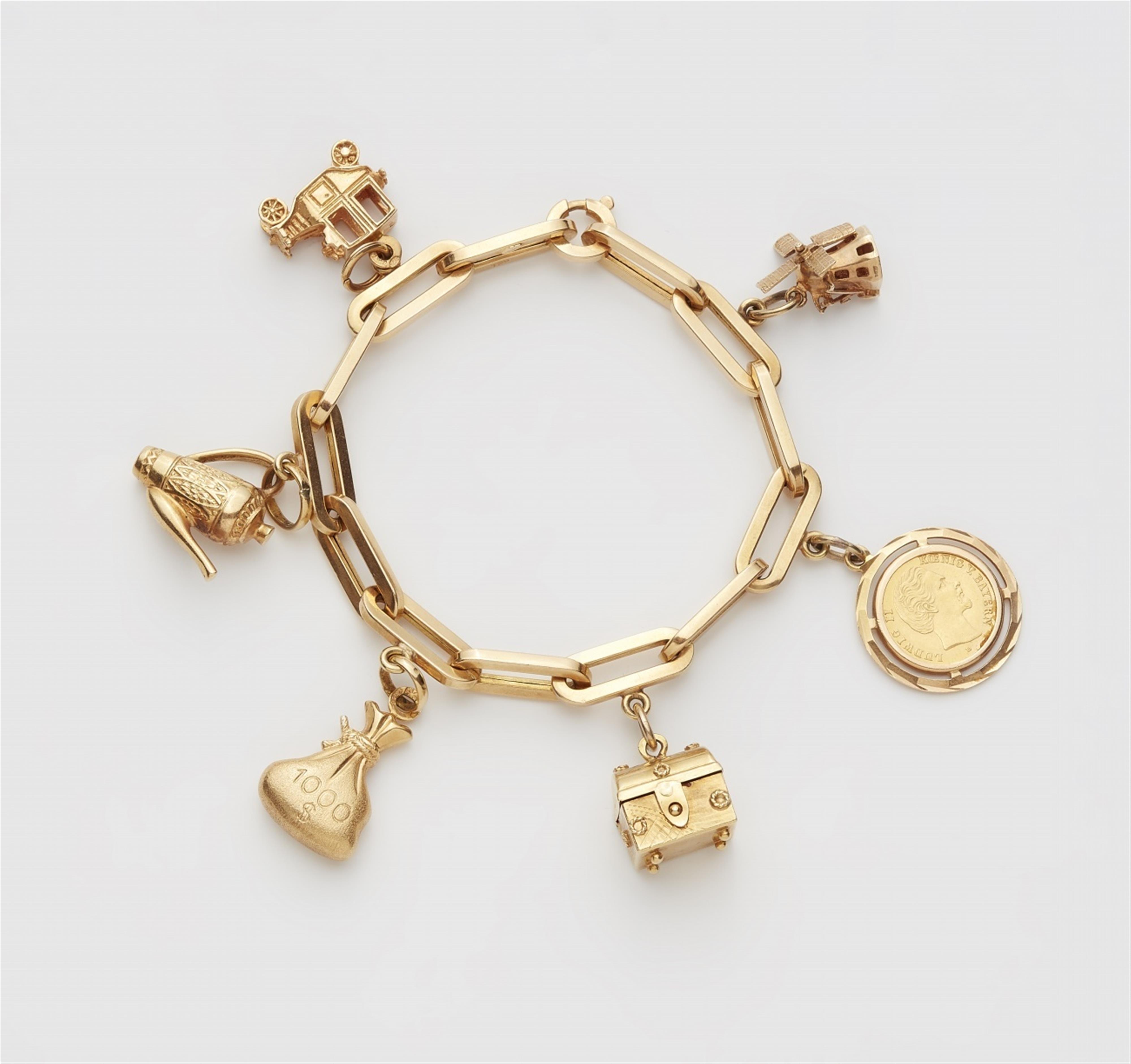 An 18k gold charm bracelet - Lot 173