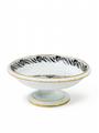 A footed porcelain bowl with floral and foliate enamel decor and gilt edging. - image-1