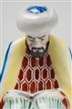 A porcelain figure of a man in a turban reading the Koran. - image-2