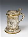 A Nuremberg silver gilt tankard. Of cylindrical form on a bulbous base, the rim moulded and the volute handle decorated with a female herm. The body engraved and embossed with biblical scenes in three oval reserves: 1. The creation of Eve, 2. The annuncia - image-1
