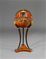 An inlaid walnut globe table. - image-1