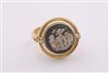 An 18k gold twisting ring with a Roman cameo. - image-3